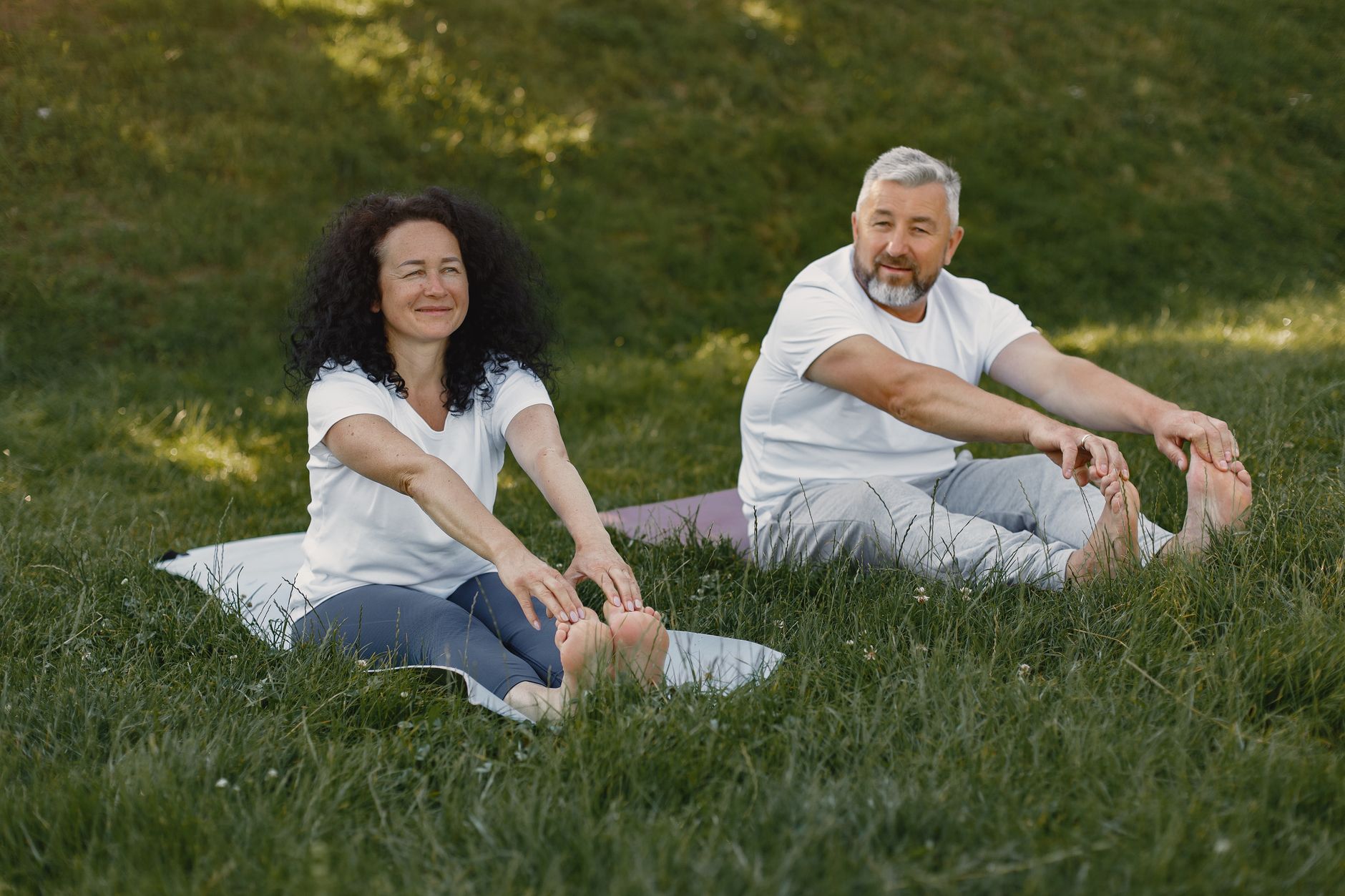 A Couple Doing Yoga Together at a Park