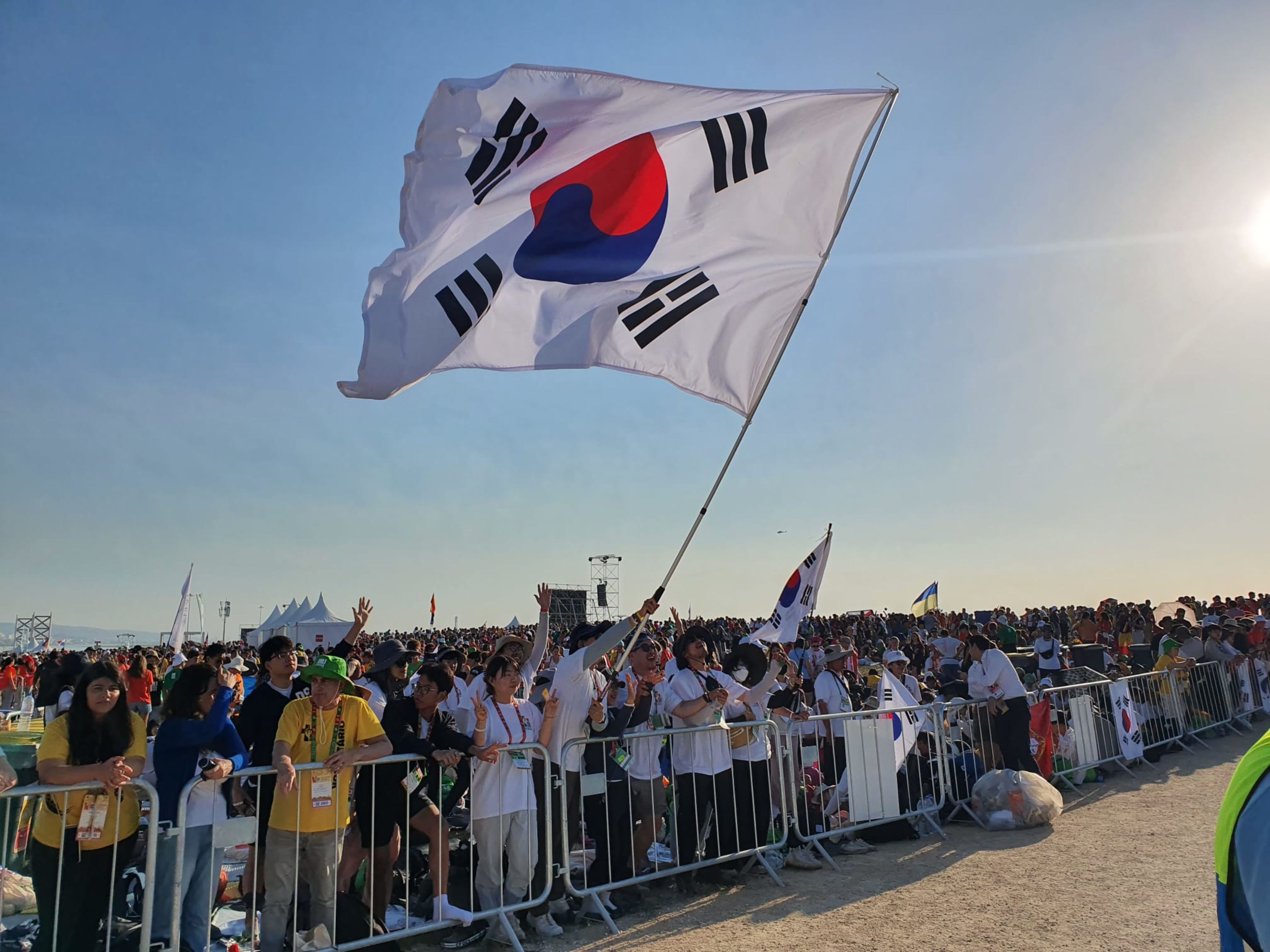 Pilgrims from South Korea wave a flag at the closing Mass of World Youth Day Lisbon with Pope Francis on Aug. 6, 2023. | Credit: Hannah Brockhaus/EWTN News
