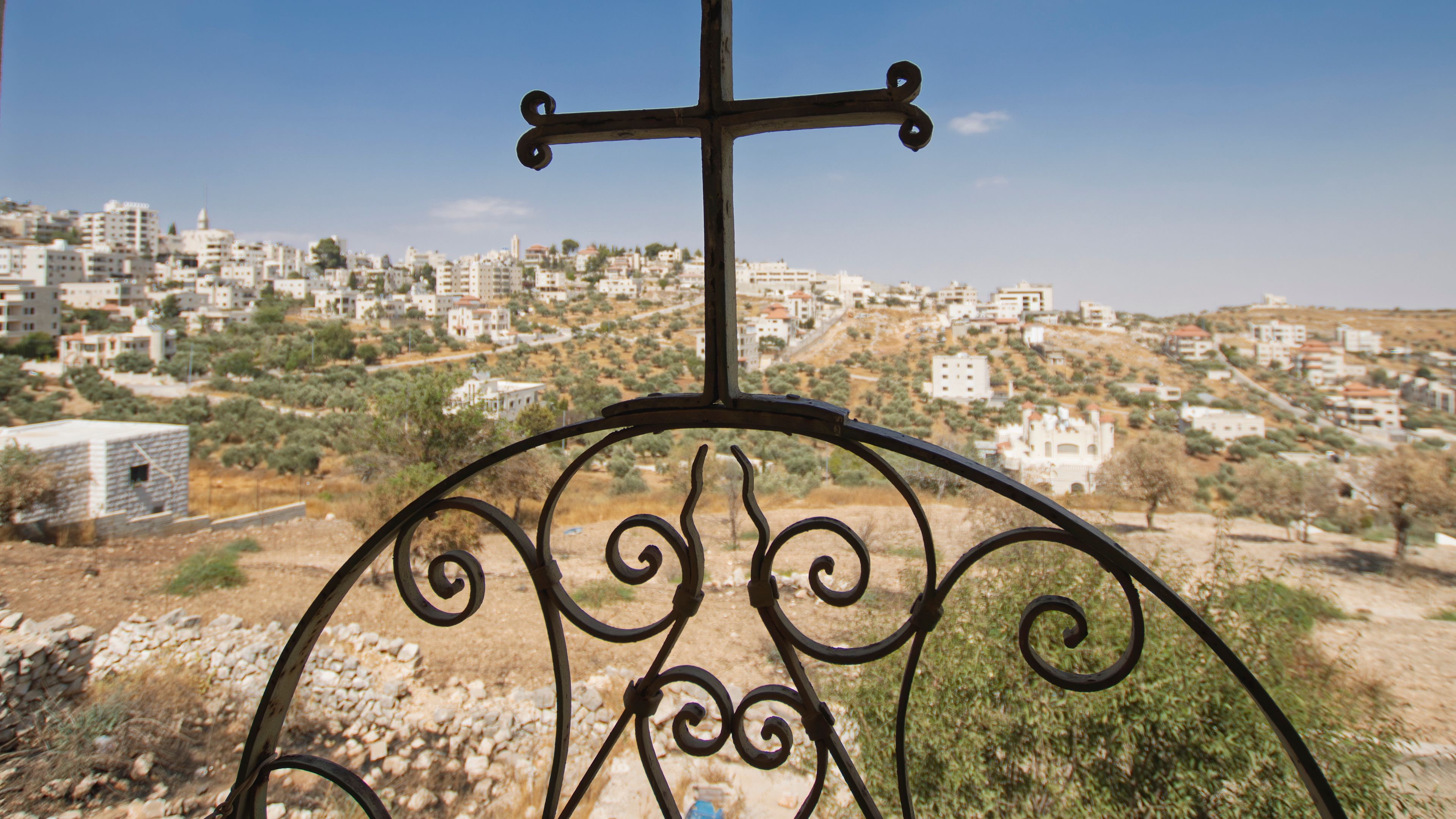 A cross overlooks Taybeh, the last Palestinian town in the West Bank with an entirely Christian population, bearing witness to the community’s resilience amid escalating attacks. | Credit: Sanad Sahelia