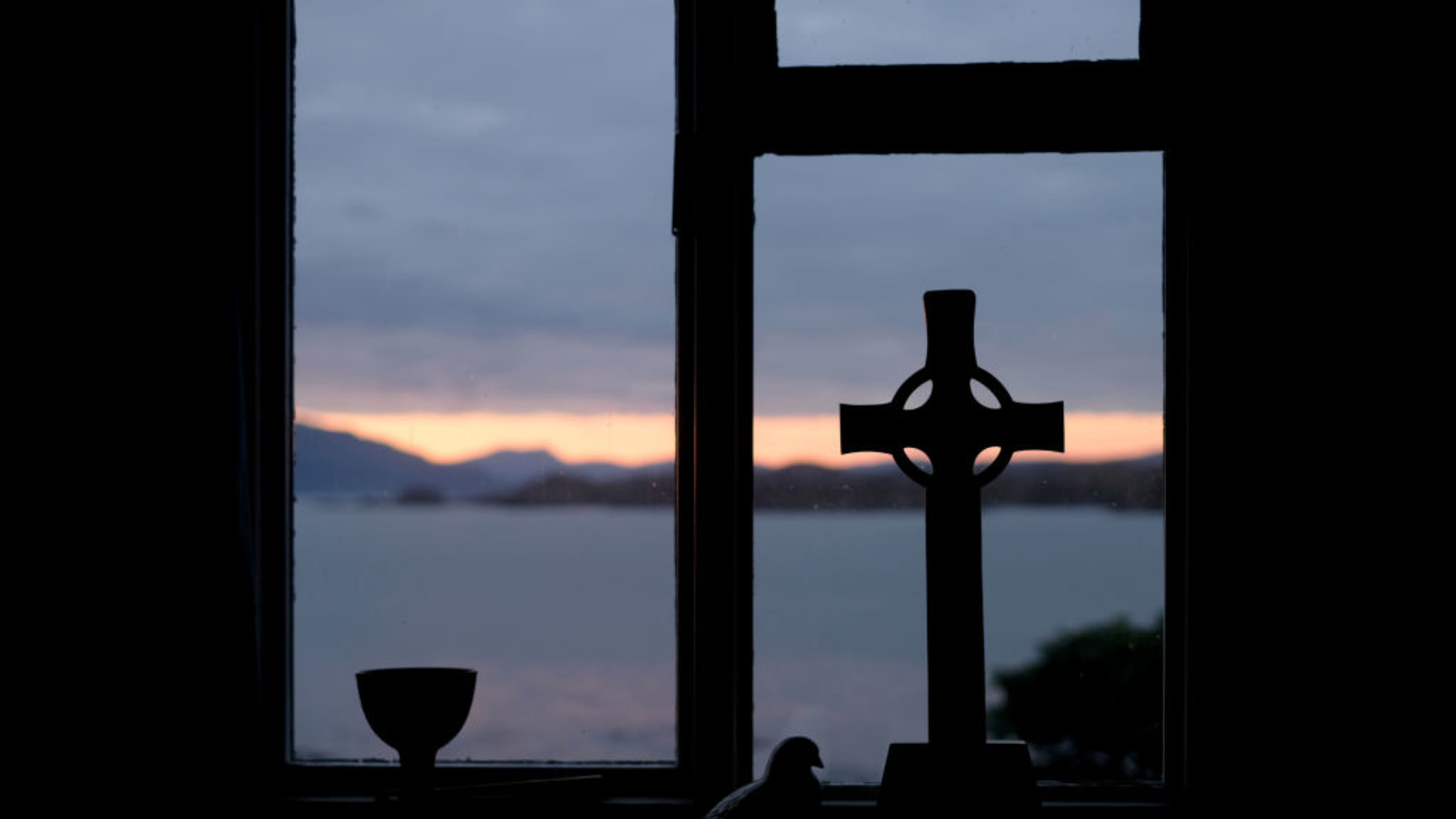A celtic cross is seen at dawn inside a retreat house on the Isle of Iona, July 7, 2018, in the Inner Hebrides off the western coast of Scotland. | Credit: Yuriko Nakao/Getty Images