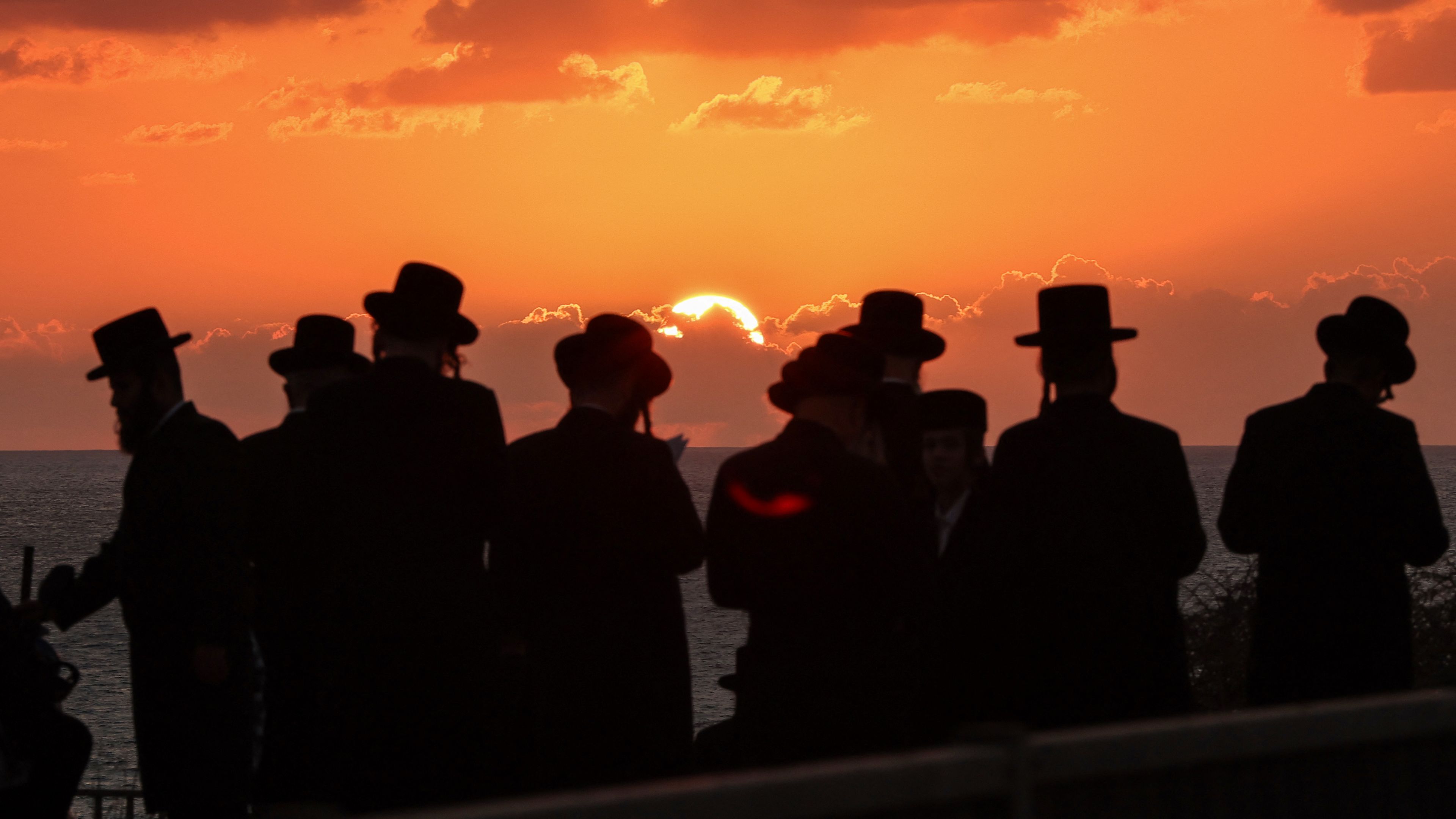 Orthodox Jewish men perform the "Tashlich" ritual, during which "sins are cast into the water to the fish," in Israel's coastal city of Netanya, on Sept. 30, 2025, ahead of the Day of Atonement, or Yom Kippur, the most important day in the Jewish religious calendar. | Credit: Jack GUEZ / AFP