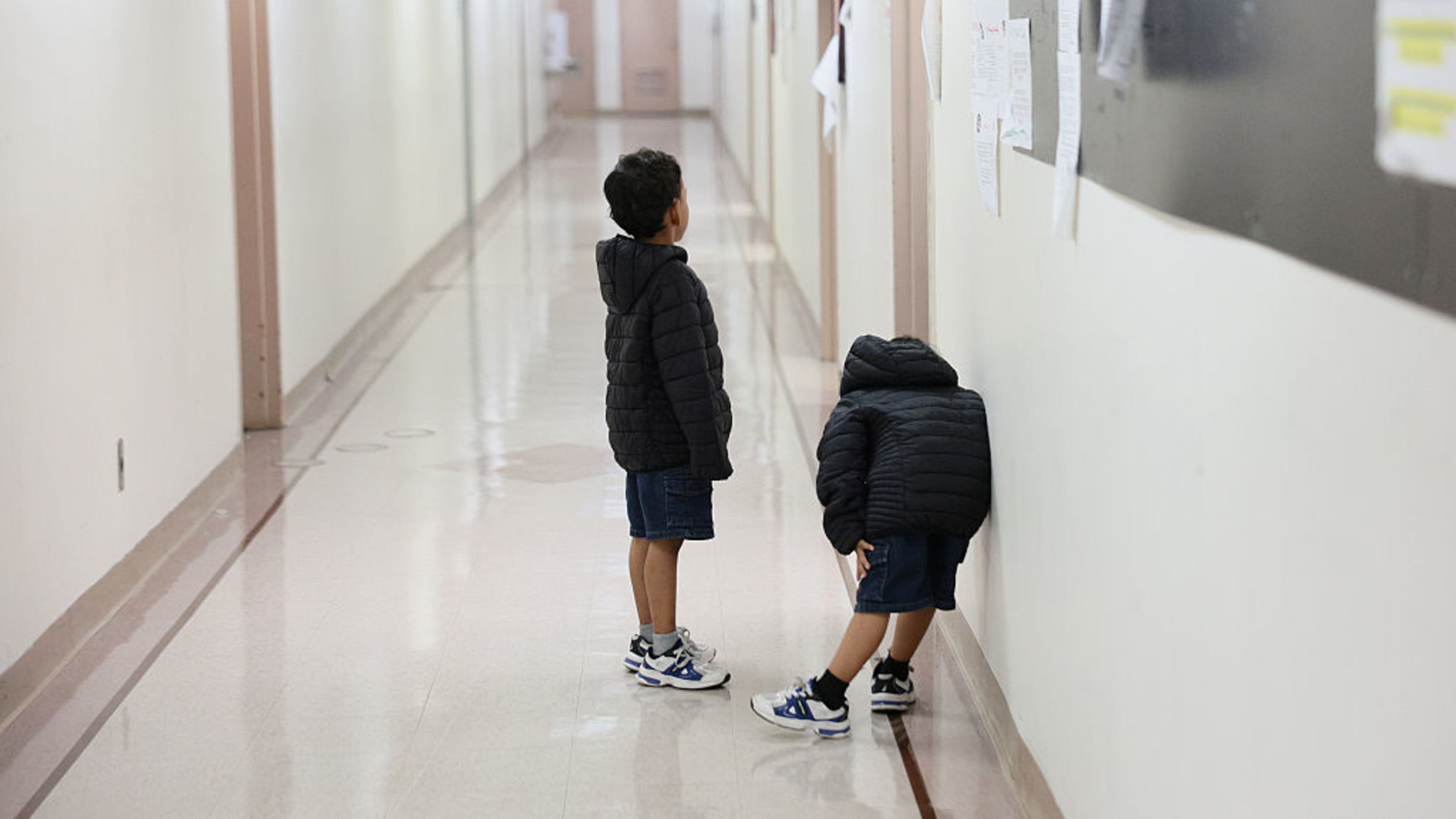 Children wait outside of an immigration court at the Jacob K. Javits Federal Building on July 31, 2026, in New York. | Credit: Michael M. Santiago/Getty Images