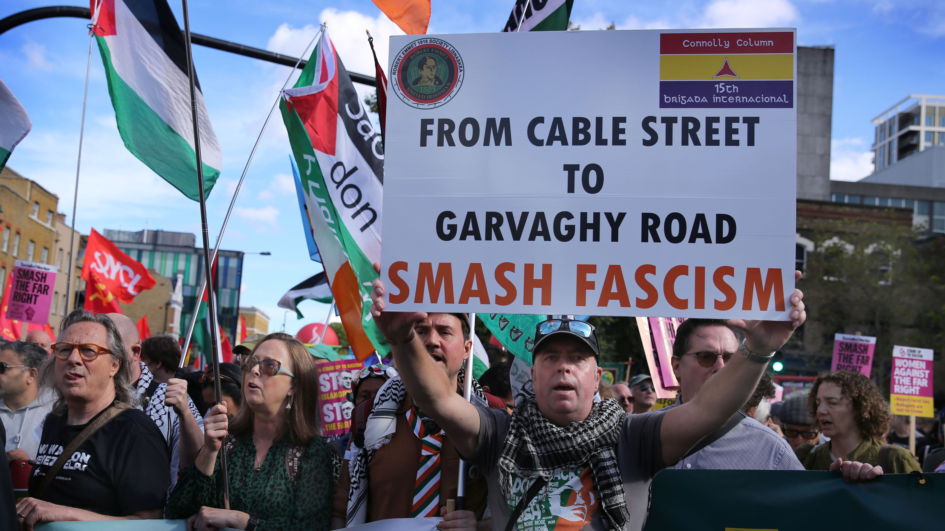 An Irish Republican supporter seen holding a sign saying 'From Cable Street To Garvaghy Road, Smash Fascism' during a rally. The 90th anniversary of the Battle of Cable Street was commemorated on Oct. 4, in the east end of London, while Garvaghy Road in Portadown, Northern Ireland is the site of a recent dispute involving unionists and Irish Republicans. | Credit: Martin Pope/SOPA Images/LightRocket via Getty Images
