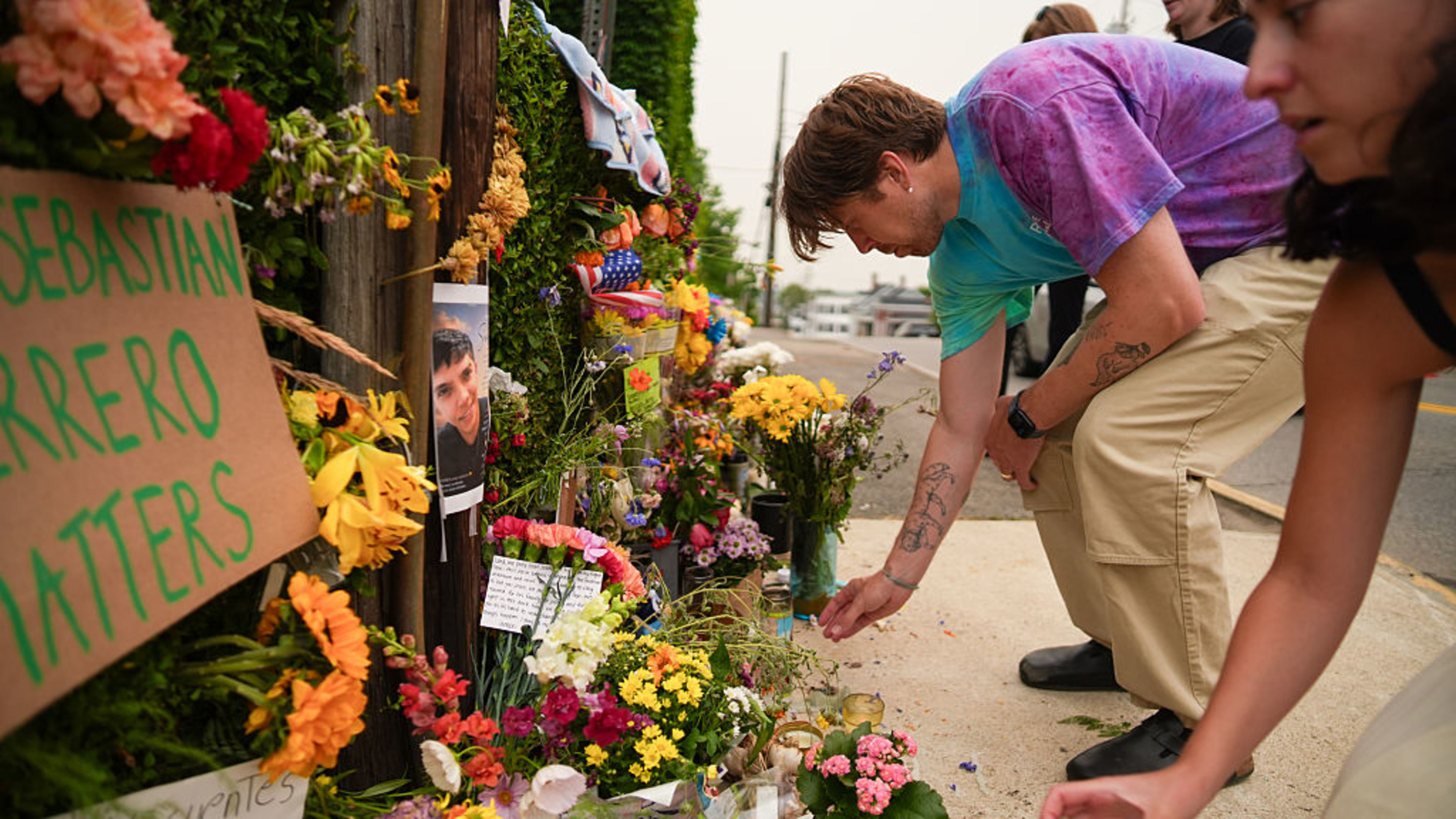 People place candles at a makeshift memorial for Johan Sebastián Durán Guerrero, a 26-year-old Colombian immigrant who was fatally shot by U.S. Immigration and Customs Enforcement (ICE) agents on July 13, 2026, in Biddeford, Maine. | Credit: Ryan Murphy/Getty Images