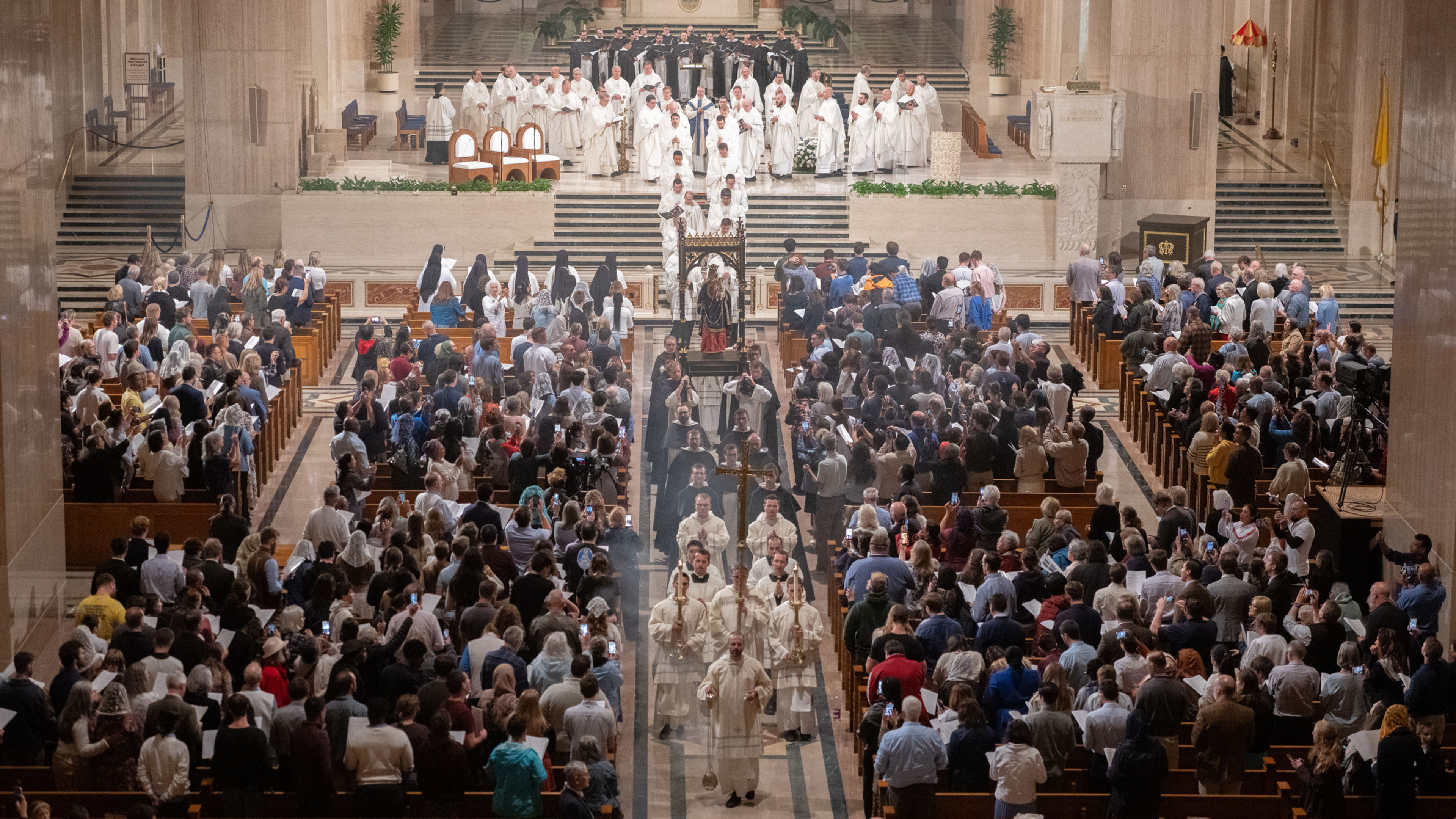 Clergy and Dominican friars process down the center aisle with a statue of Mary and the infant Jesus as standing pilgrims watch at the Basilica of the National Shrine of the Immaculate Conception in Washington, D.C., for the Dominican Rosary Pilgrimage on Saturday, Sept. 26, 2026. | Credit: Jeffrey Bruno