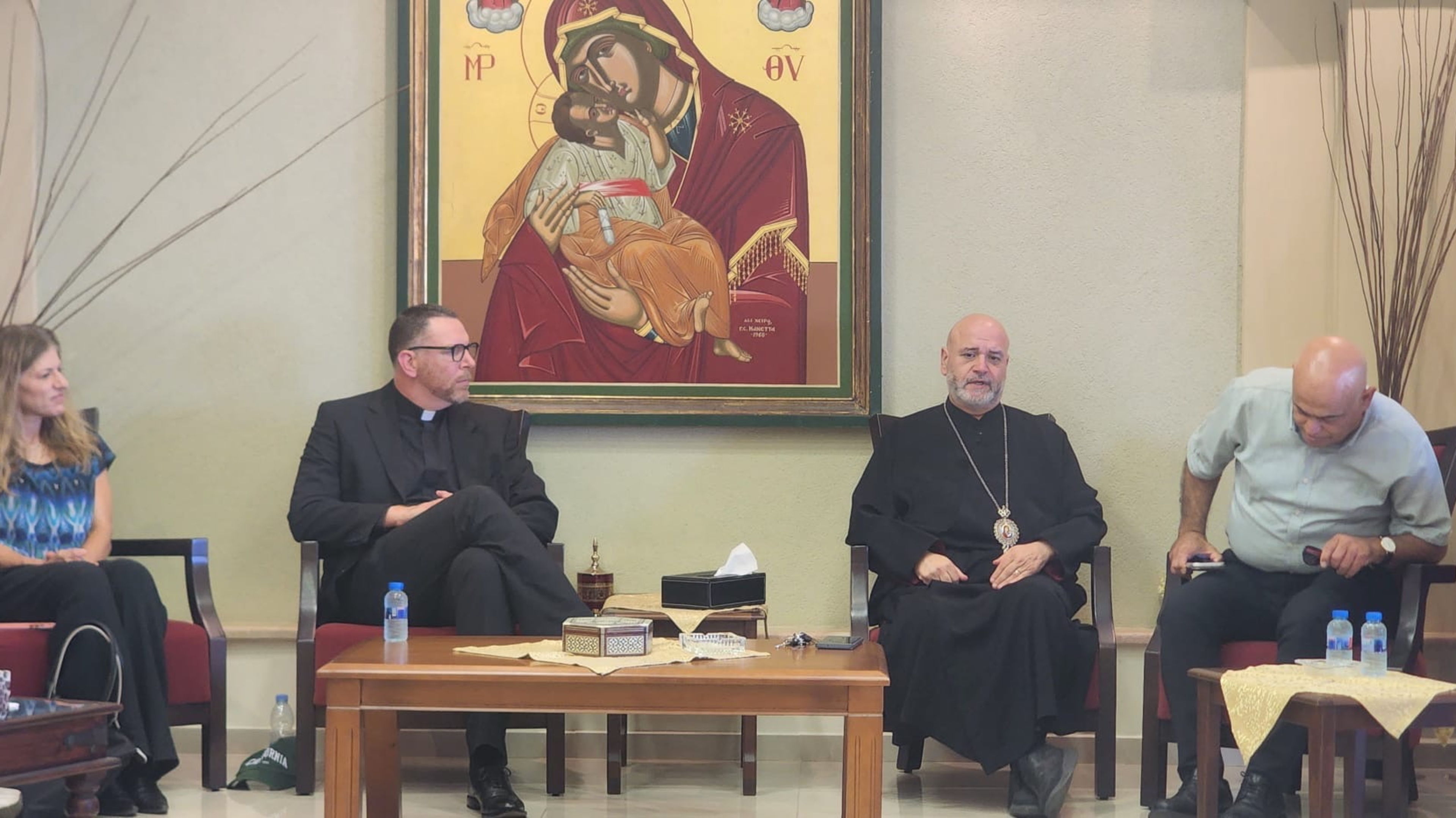 View of Aug. 13, 2026, meeting attended by a delegation of U.S. Catholic influencers in Haifa, Israel, with, from left to right: Tammy Ben-Haim, head of Religious and Interfaith Affairs, Israel Ministry of Foreign Affairs; Father Stephen Akers of the Diocese of Monterey, California; Archbishop Youssef Matta, Melkite Greek archbishop of Acre, Haifa, Nazareth, and All Galilee; and Cesare Marjieh, senior director of the Christian Department of Israel’s Ministry of Interior Affairs. | Credit: Photo courtesy of Catherine Szkop