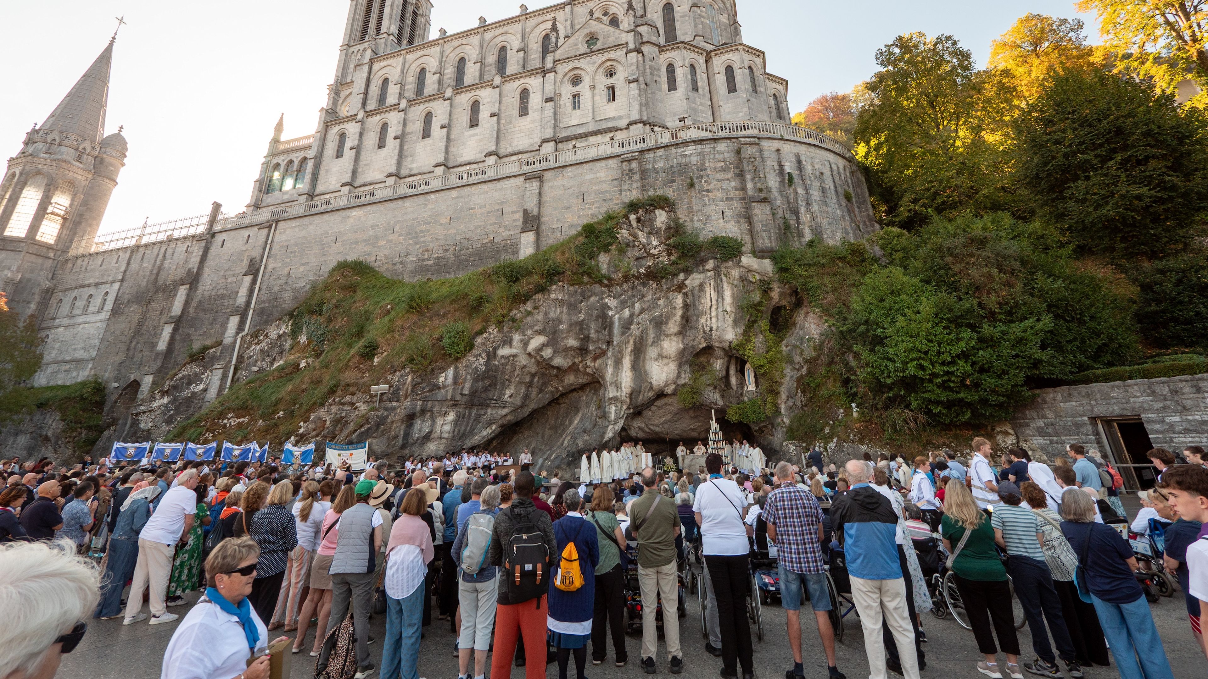 Pilgrims gather at the foot of the grotto in Lourdes where Our Lady appeared to St. Bernadette in 1858 on Sept. 25 as they wait for Pope Leo's visit as part of his three-day papal trip to France. | Credit: Elliot Hartley