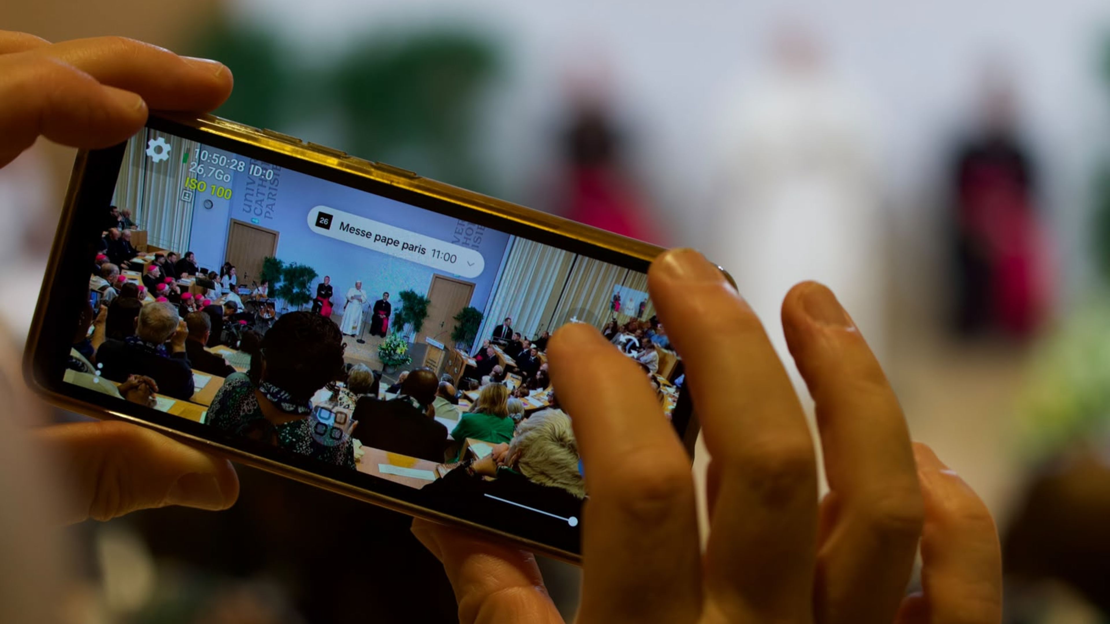 A participant takes a video recording of Pope Leo XIV’s visit to the Institut Catholique de Paris on Sept. 26, 2026. The pope met with members of the provincial Synodal Assembly, catechumens, and the newly baptized. | Credit: Daniel Ibáñez/EWTN News