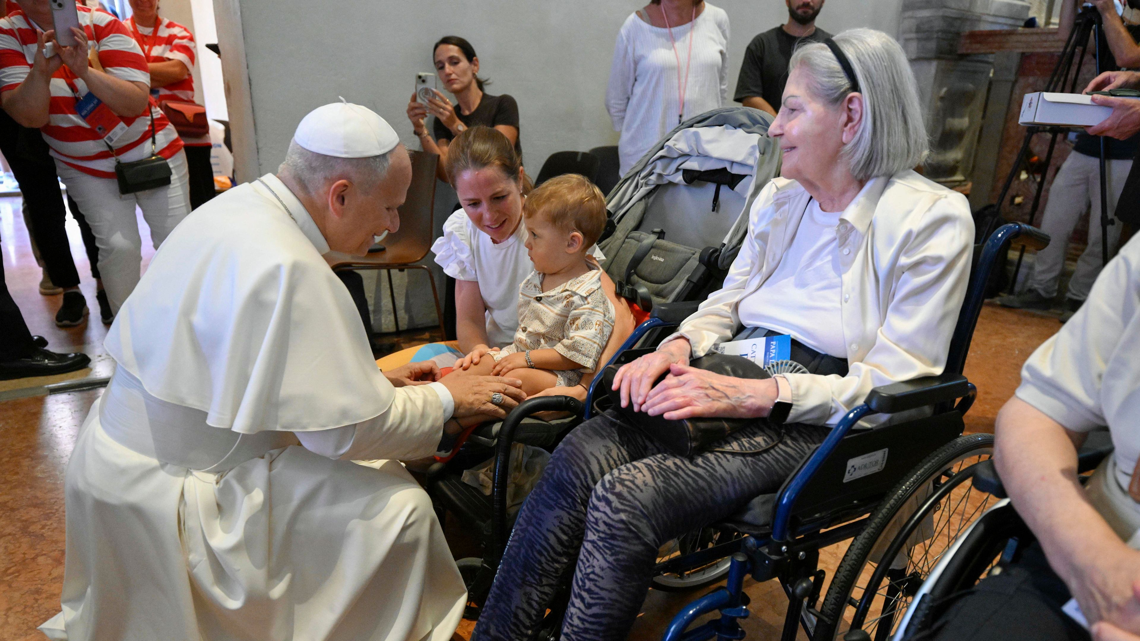 Pope Leo XIV greets a boy in a wheelchair at Rimini Cathedral, Aug. 22, 2026, during a meeting with people suffering from illnesses and disabilities. | Credit: Vatican Media