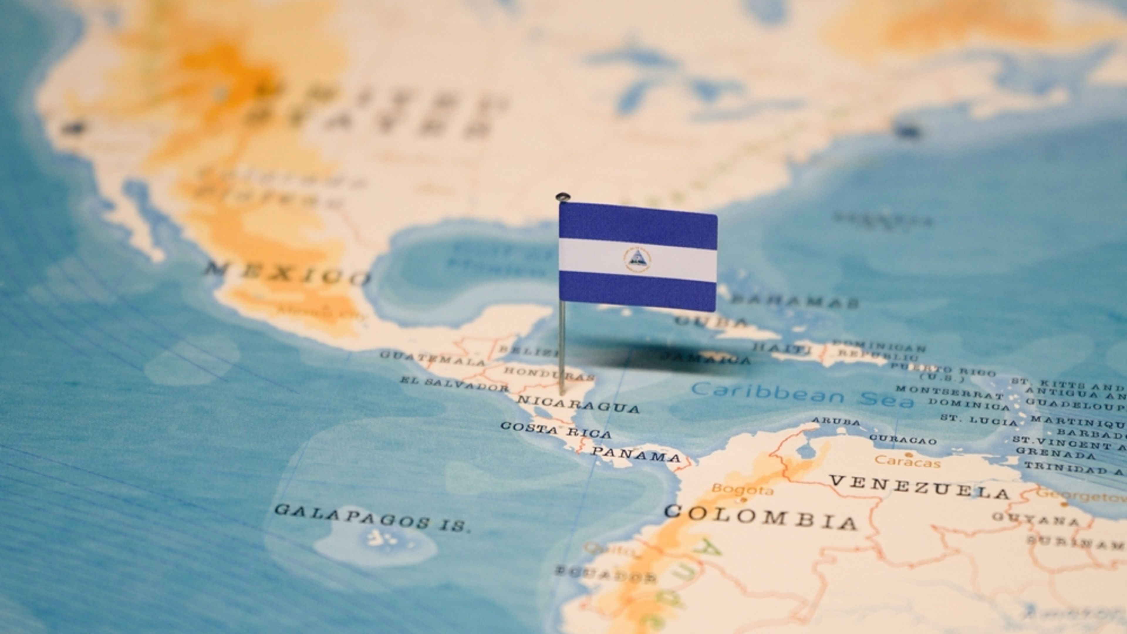 The flag of Nicaragua on the world map. | Credit: hyotographics/Shutterstock