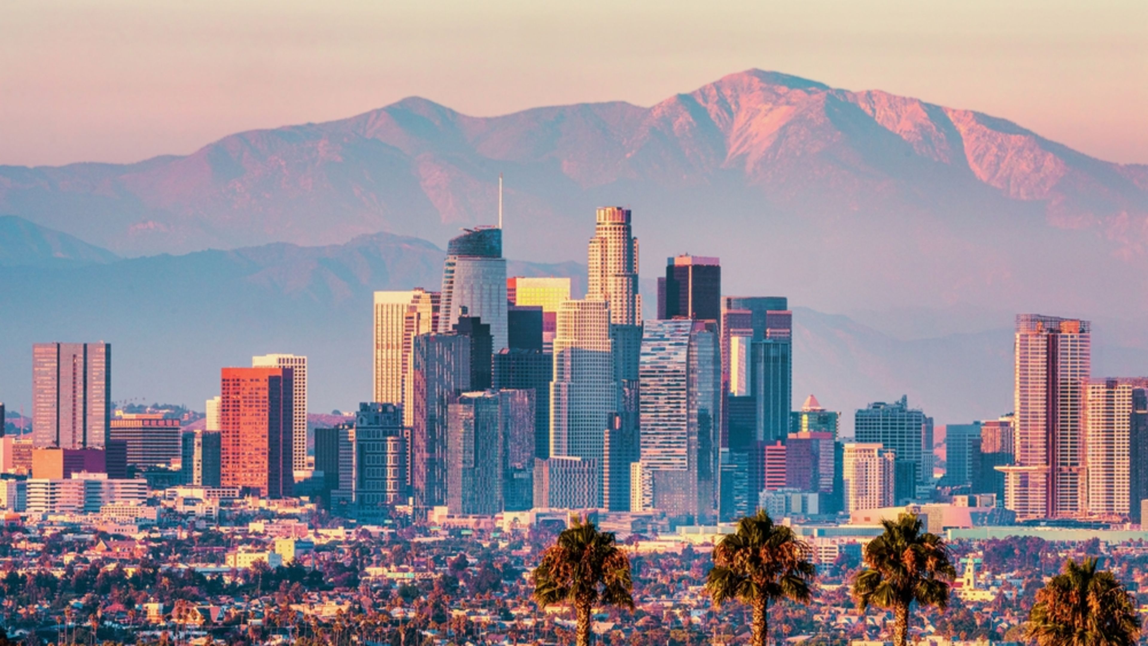 Downtown Los Angeles at sunset with the San Gabriel Mountains in the background. | Credit: UVL/Shutterstock