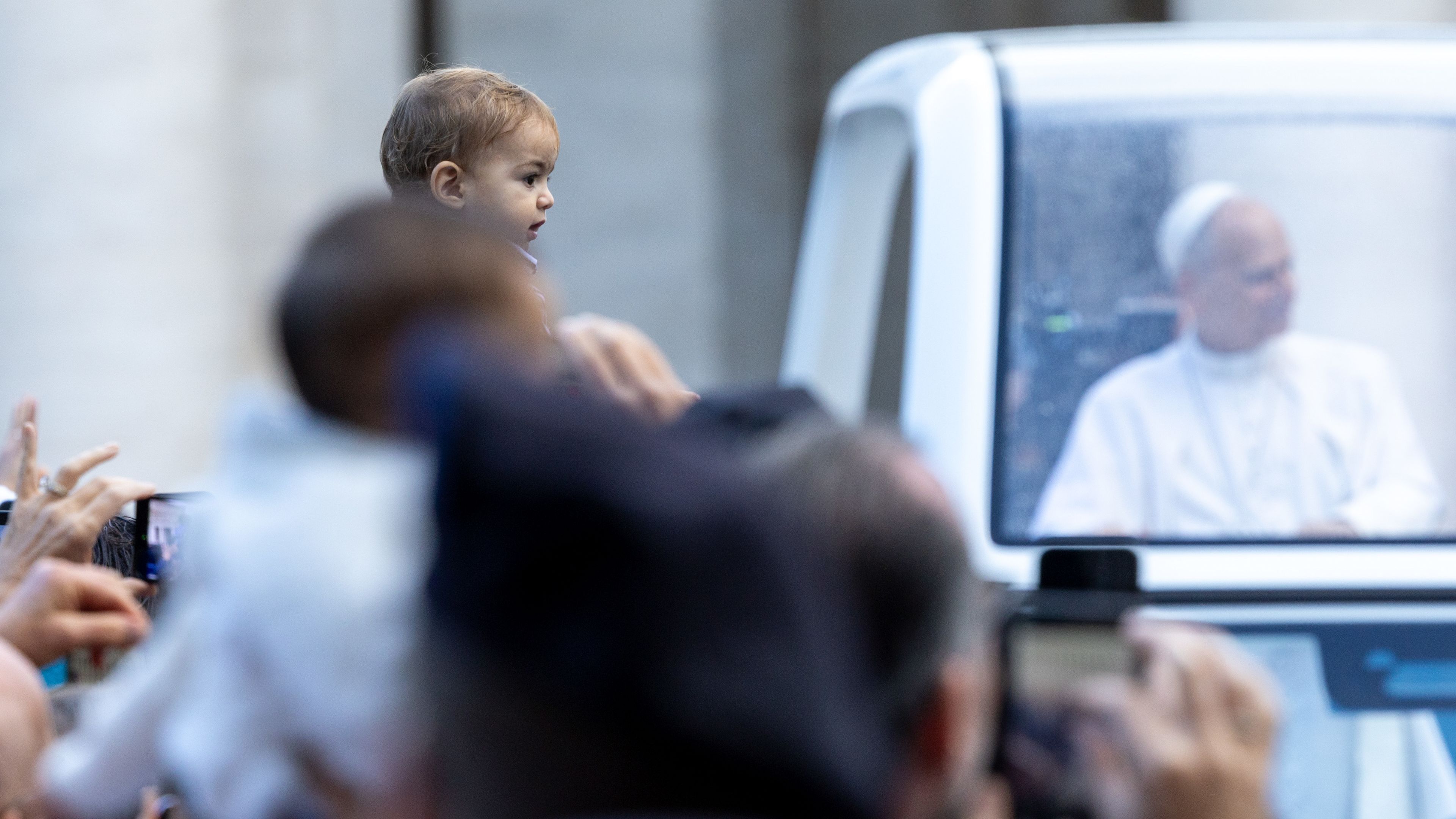 A child is held up for Pope Leo XIV to bless when he passes by in the popemobile during the general audience in St. Peter’s Square on Oct. 21, 2026. | Credit: Daniel Ibáñez/EWTN News