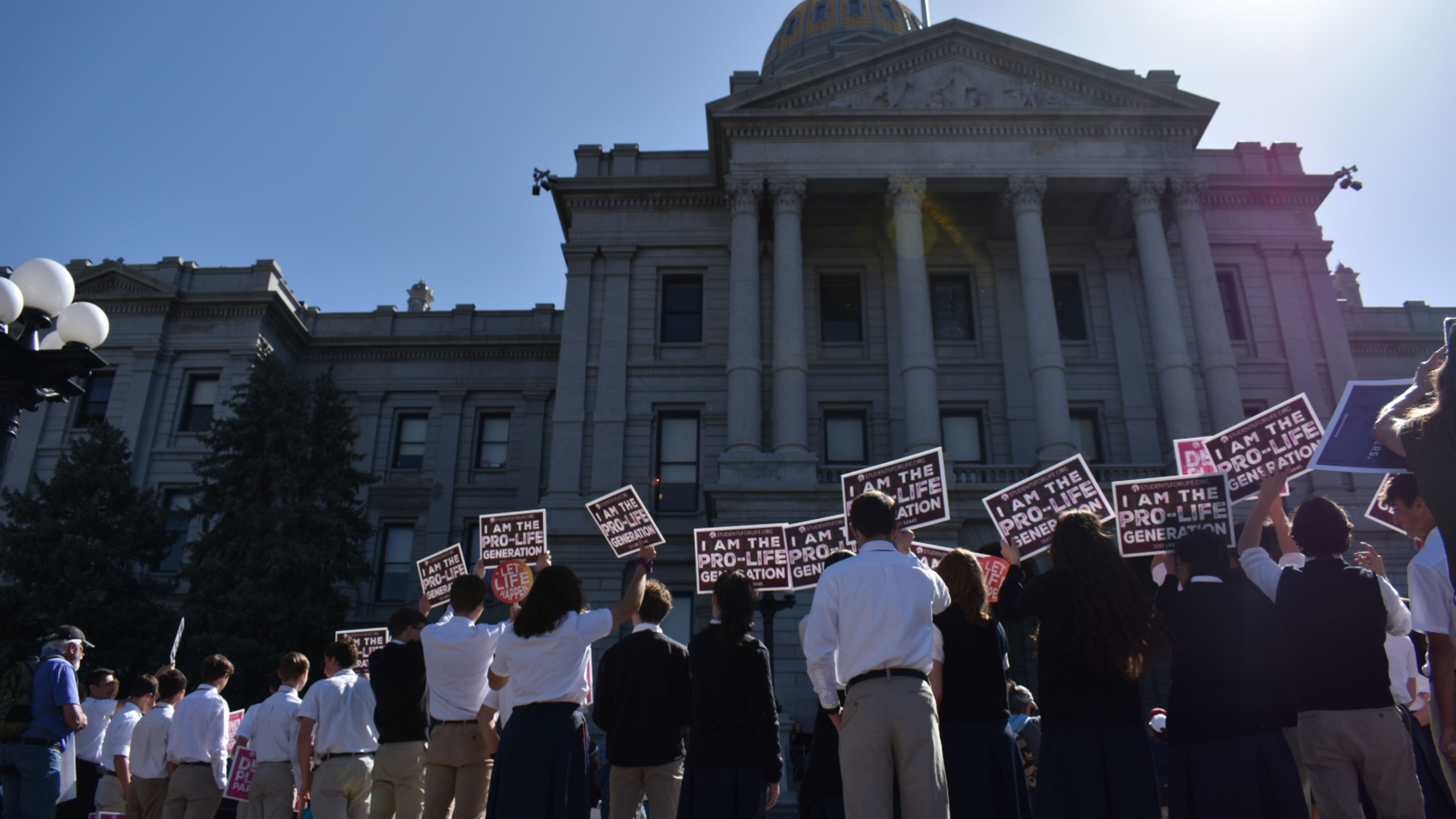 Catholic school students in uniform hold “I am the Pro-Life Generation” signs at the Colorado March for Life in Denver on Friday, April 11, 2025. | Credit: Kate Quiñones/EWTN News