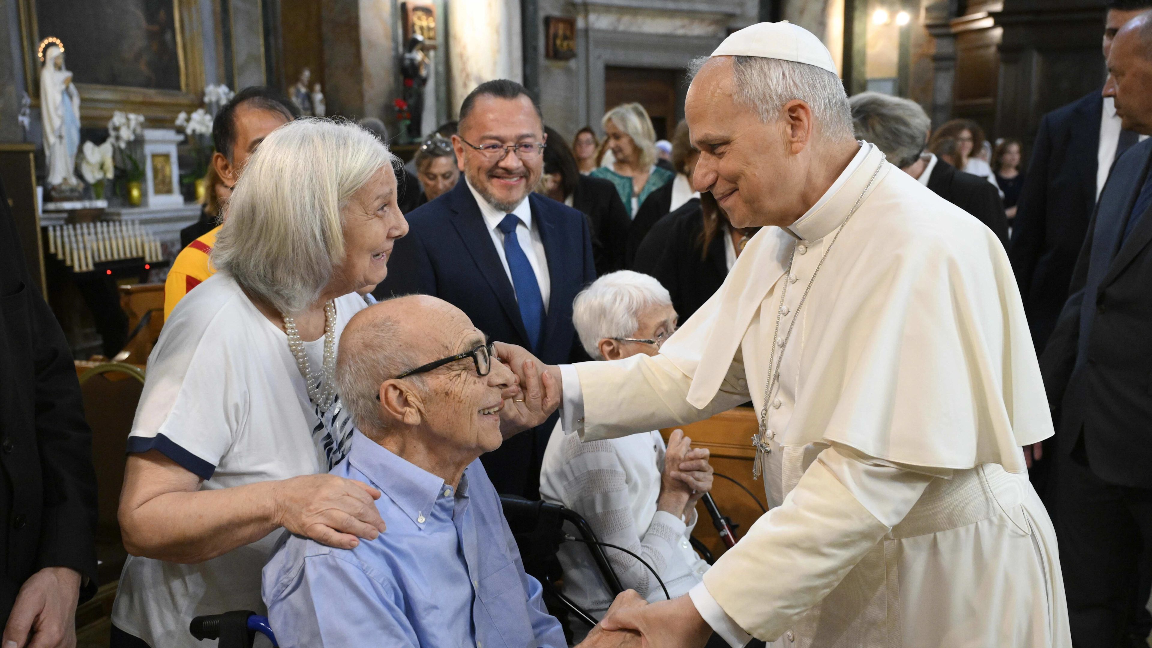 Pope Leo speaks with a couple at the Parish Church of St. Anne in the Vatican on Sept. 21, 2025. | Credit: Vatican Media