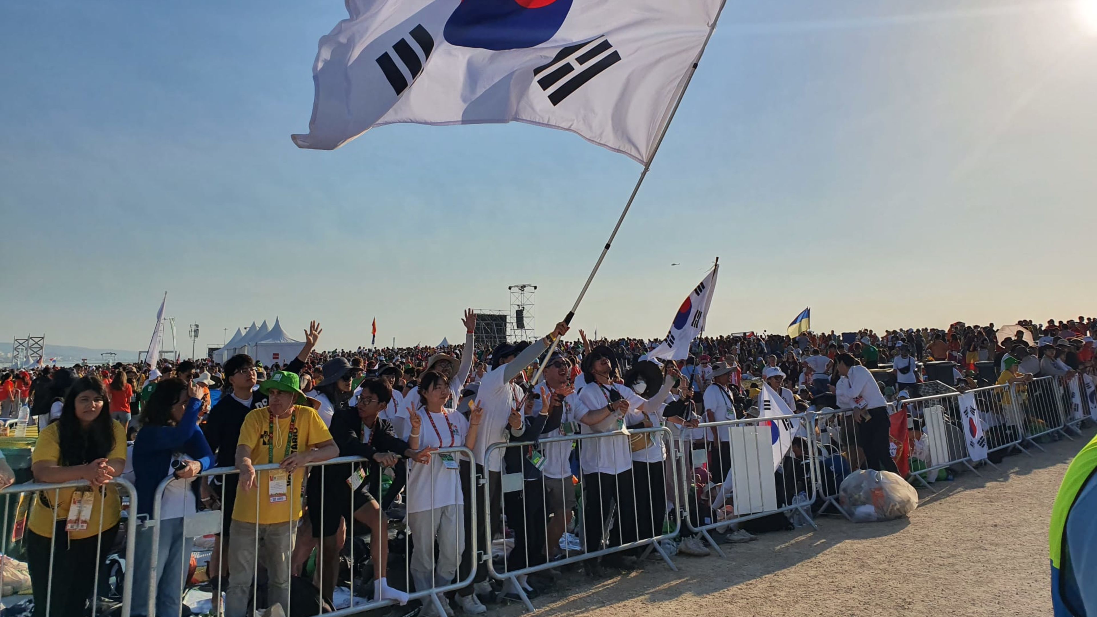 Pilgrims from South Korea wave a flag at the closing Mass of World Youth Day in Lisbon, Portugal, with Pope Francis on Aug. 6, 2023. | Hannah Brockhaus/EWTN News