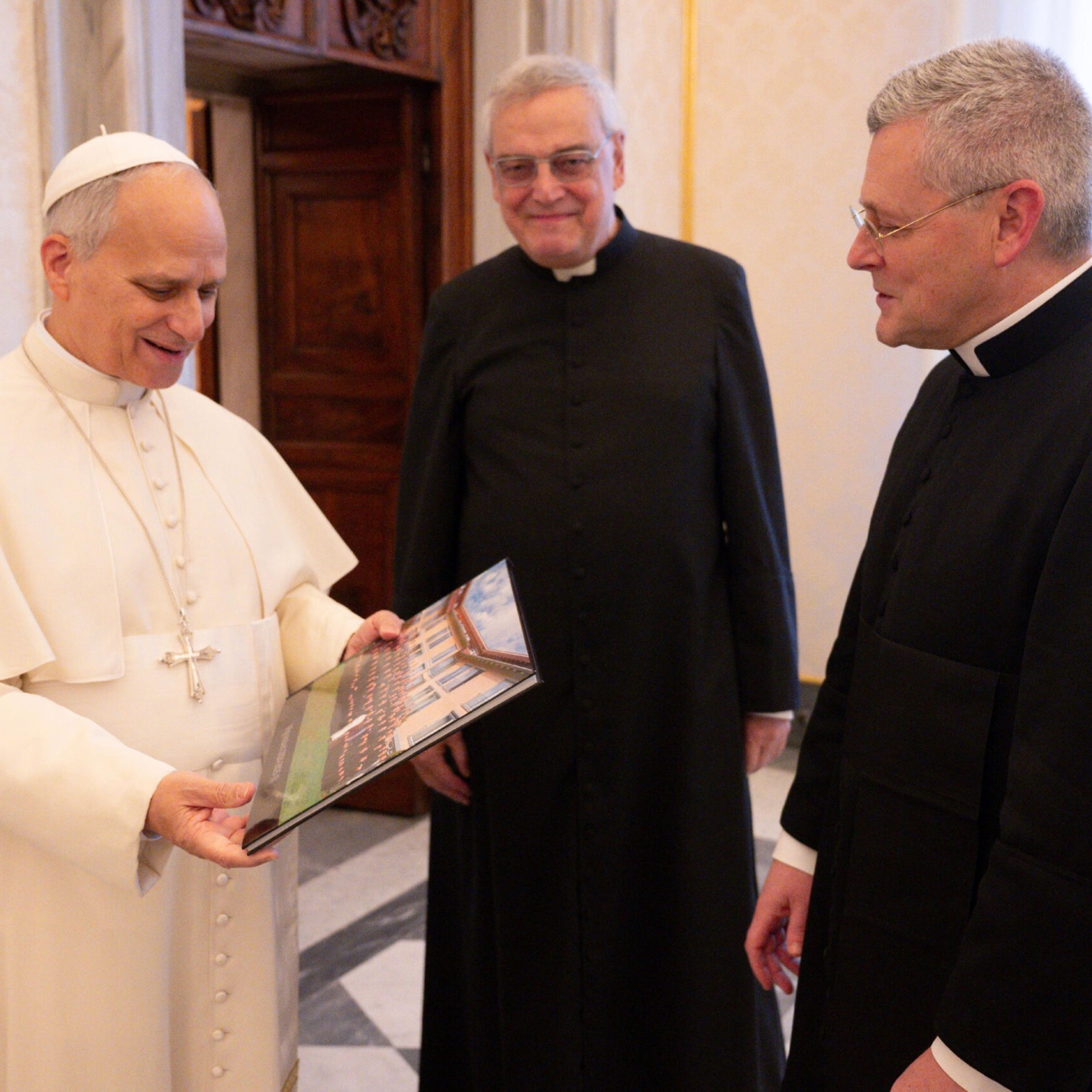 Priestly Fraternity of St. Peter Superior General Father John Berg (right) is accompanied to a Jan. 19, 2026, audience with Pope Leo XIV by Father Josef Bisig (center), a co-founder of the FSSP and its first superior general. | Credit: Vatican Media