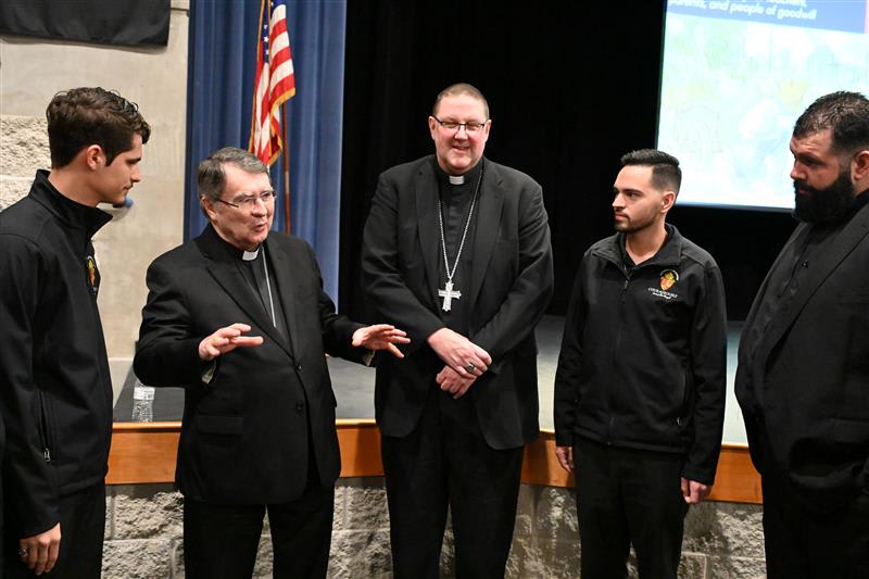 Cardinal Christophe Pierre and Bishop Gregory Parkes speak with Diocese of St. Petersburg seminarians who attended the panel discussion Jan, 24, 2024. Credit: Teresa Peterson