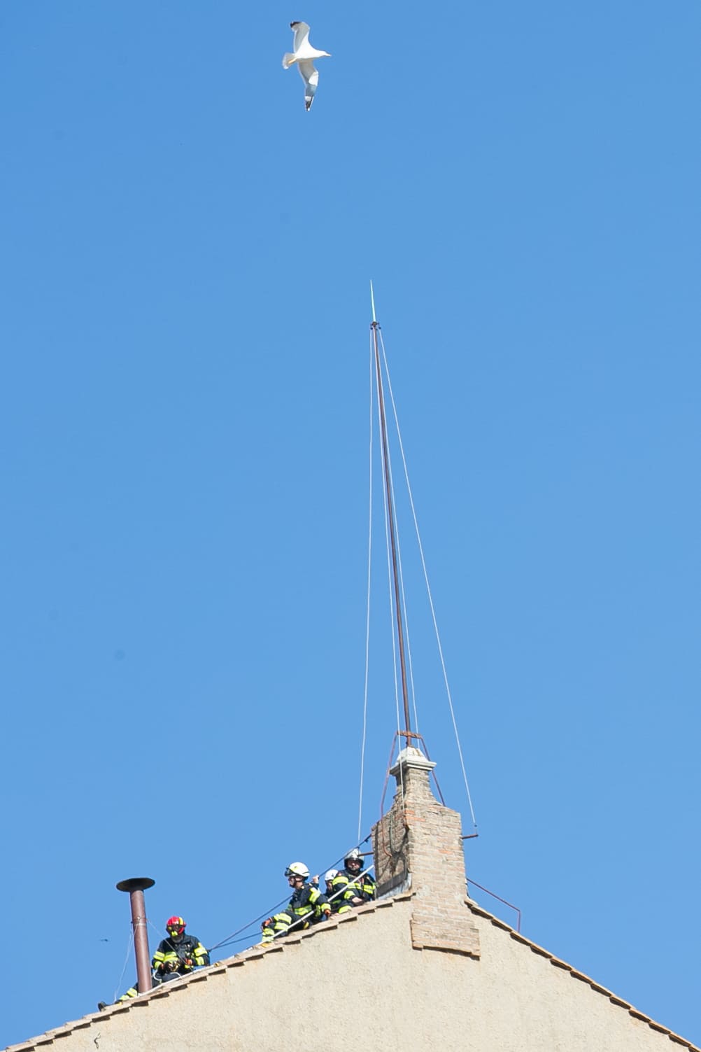 A bird flies over the Sistine Chapel as Vatican firefighters on May 2, 2025, install on the chapel roof the iconic chimney that will signal the outcome of voting during the May 7 conclave to elect Pope Francis’ successor. Credit: Daniel Ibañez/CNA