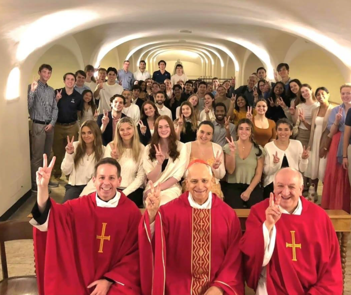 Pope Leo XIV (then Cardinal Robert Prevost) holding up the Villanova “V” hand sign with a group of Villanova students at St. Peter’s Crypt beneath St. Peter’s Basilica in October 2024. | Credit: Courtesy of Jaisy Joseph 