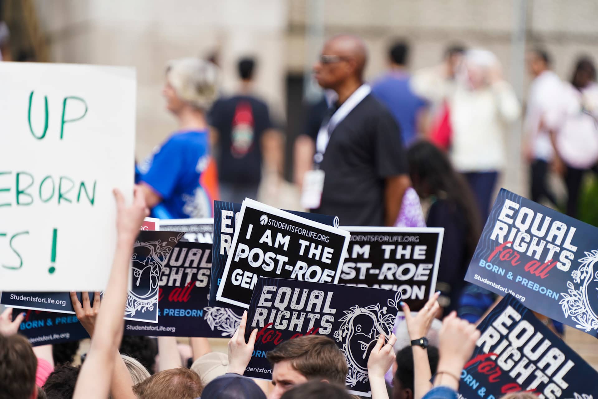 Participants in a pro-life rally hold signs in front of the Lincoln Memorial in Washington, D.C., on June 24, 2023, at a rally marking the first anniversary of the Supreme Court's Dobbs decision that...