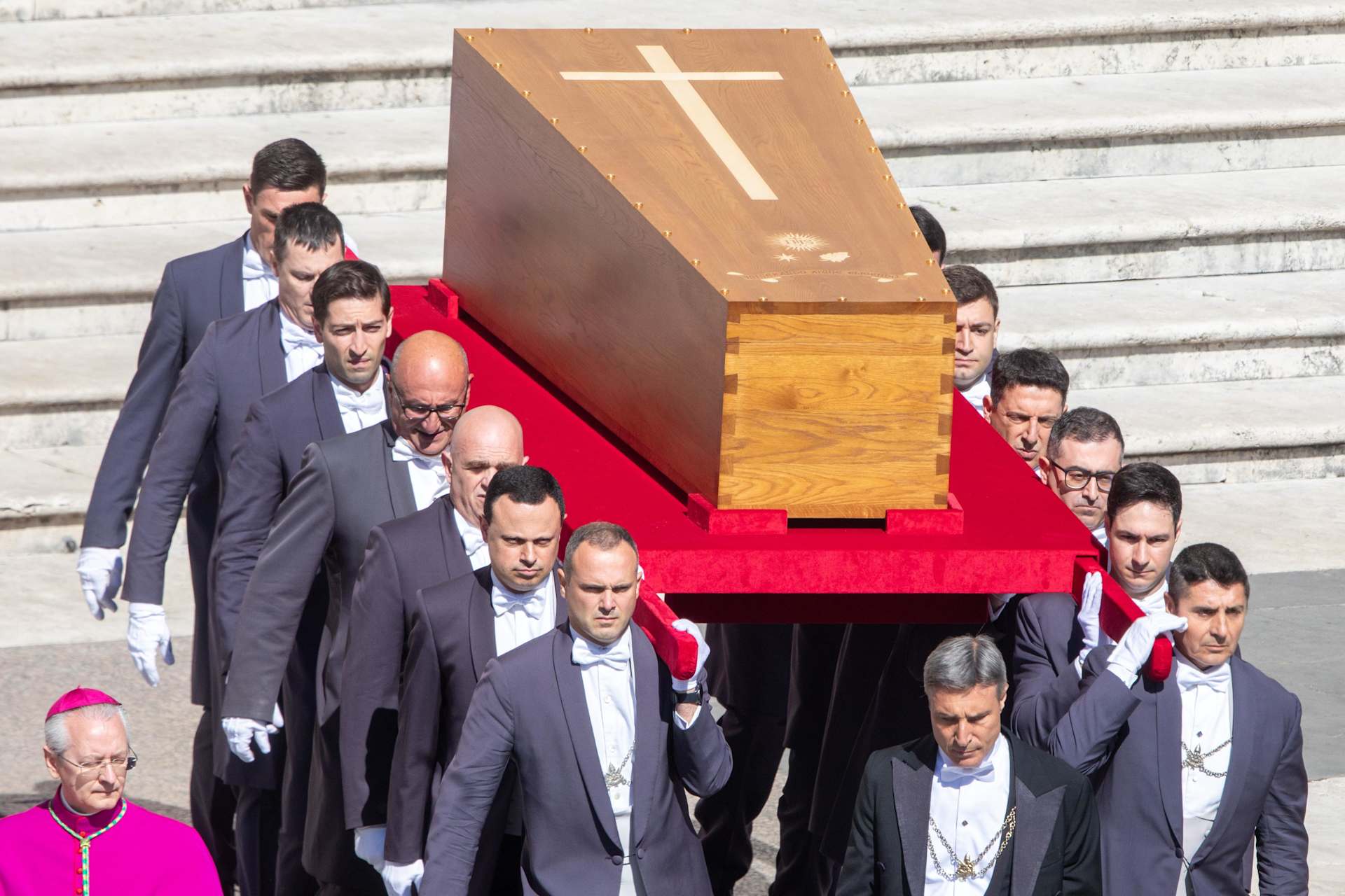 Pallbearers carry the wooden coffin of Pope Francis, marked with a cross, into St. Peter's Square for the funeral Mass on April 26, 2025. - Credit: Daniel Ibáñez/CNA