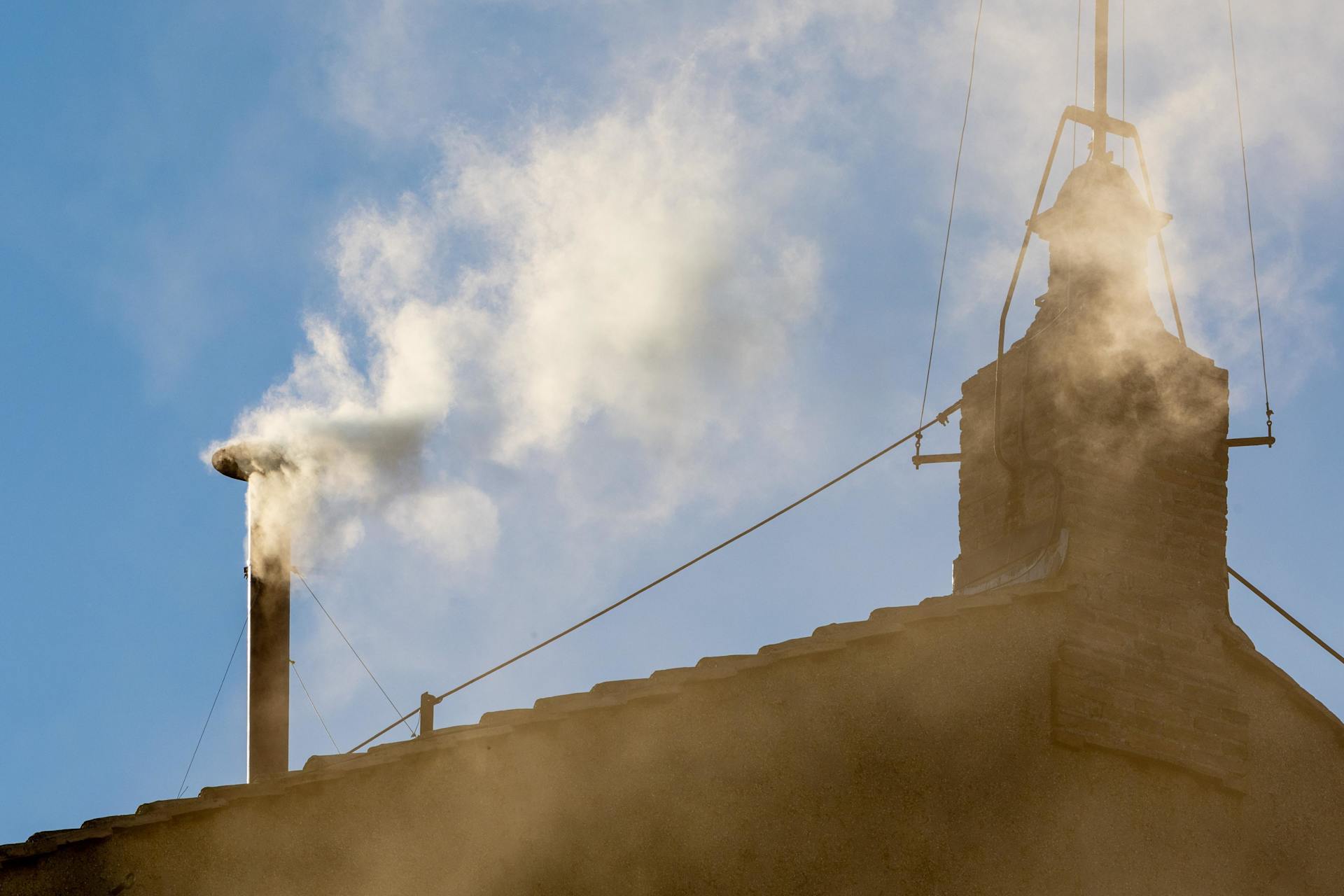 White smoke billowing from the chimney of the Sistine Chapel on May 8, 2025 as the crowds cheer on St. Peter’s Square. - Credit: Daniel Ibáñez/CNA