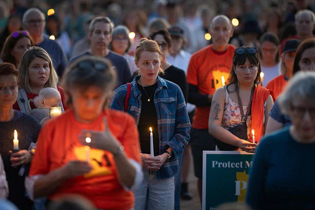 People attend a vigil at Lynnhurst Park to mourn the dead and pray for the wounded after a gunman opened fire on students at Annunciation Catholic School on Aug. 27, 2025, in Minneapolis. | Credit: Scott Olson/Getty Images