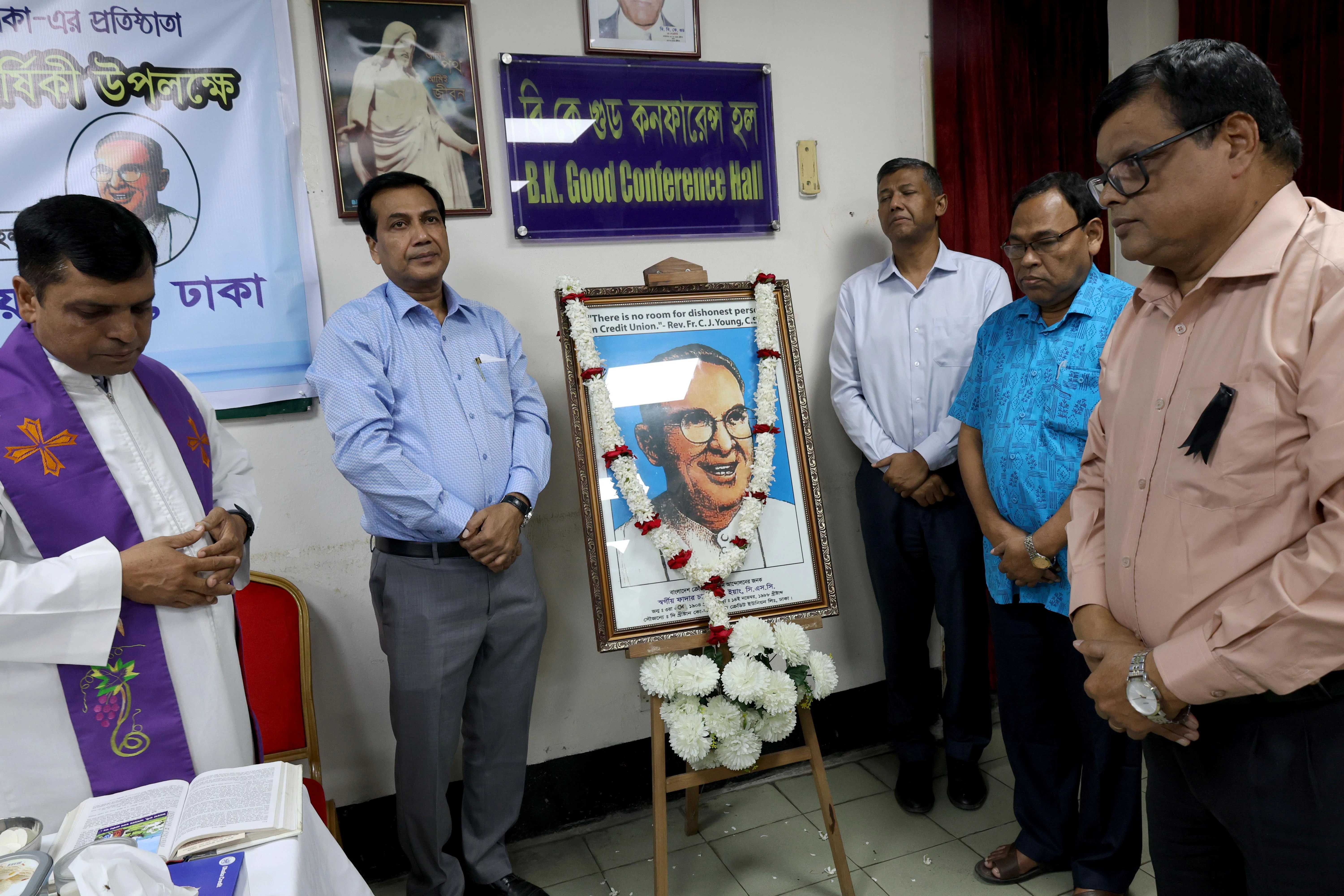 The leaders of The Christian Cooperative Credit Union Ltd. in Dhaka, Bangladesh, gather around an image of Father Charles Joseph Young, offering prayers before observing his death anniversary on Nov. 14, 2025. Credit: Stephan Uttom Rozario