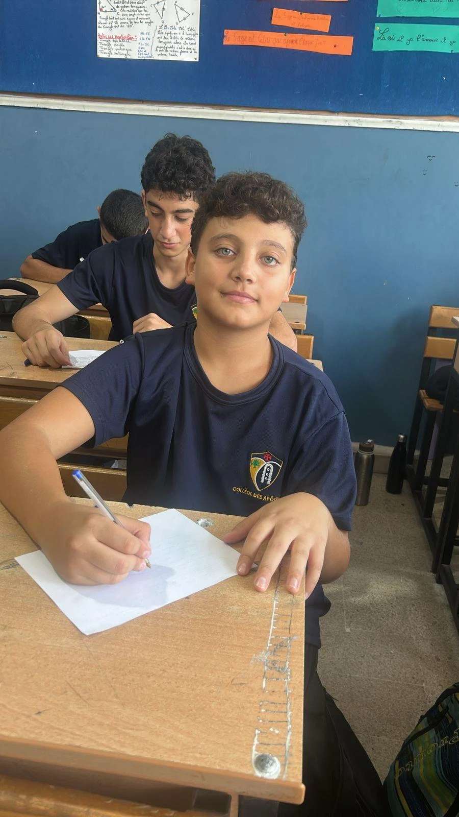 Student Chris Abi Hanna writing his letter to Pope Leo XIV. Credit: Noelle El Hajj