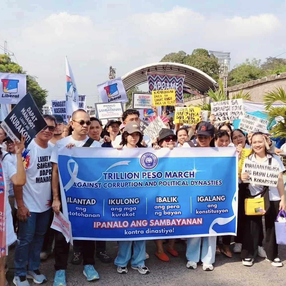 Protesters hold signs and banners during a rally against corruption at the EDSA People Power Monument in Manila on Sunday, Nov. 30, 2025. Credit: Santosh Digal