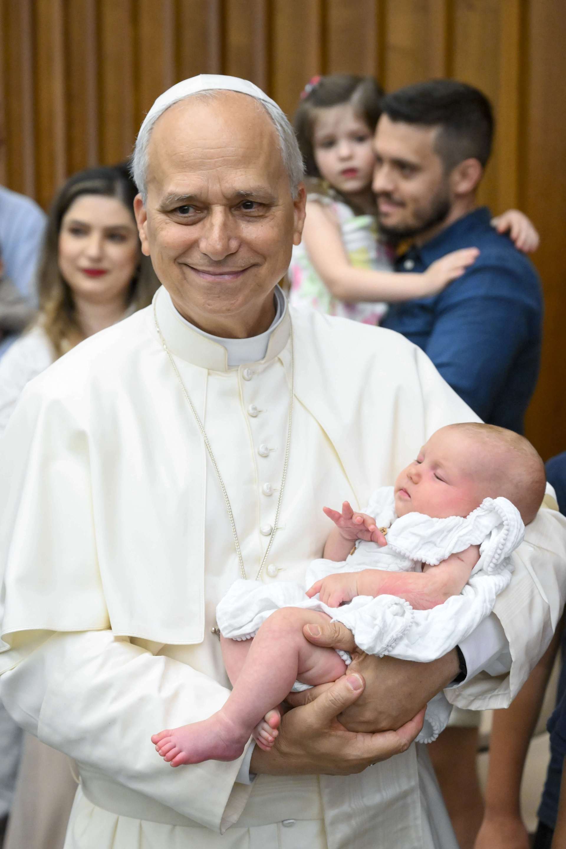 Pope Leo XIV holds a baby during an audience at the Vatican. Credit: Vatican Media