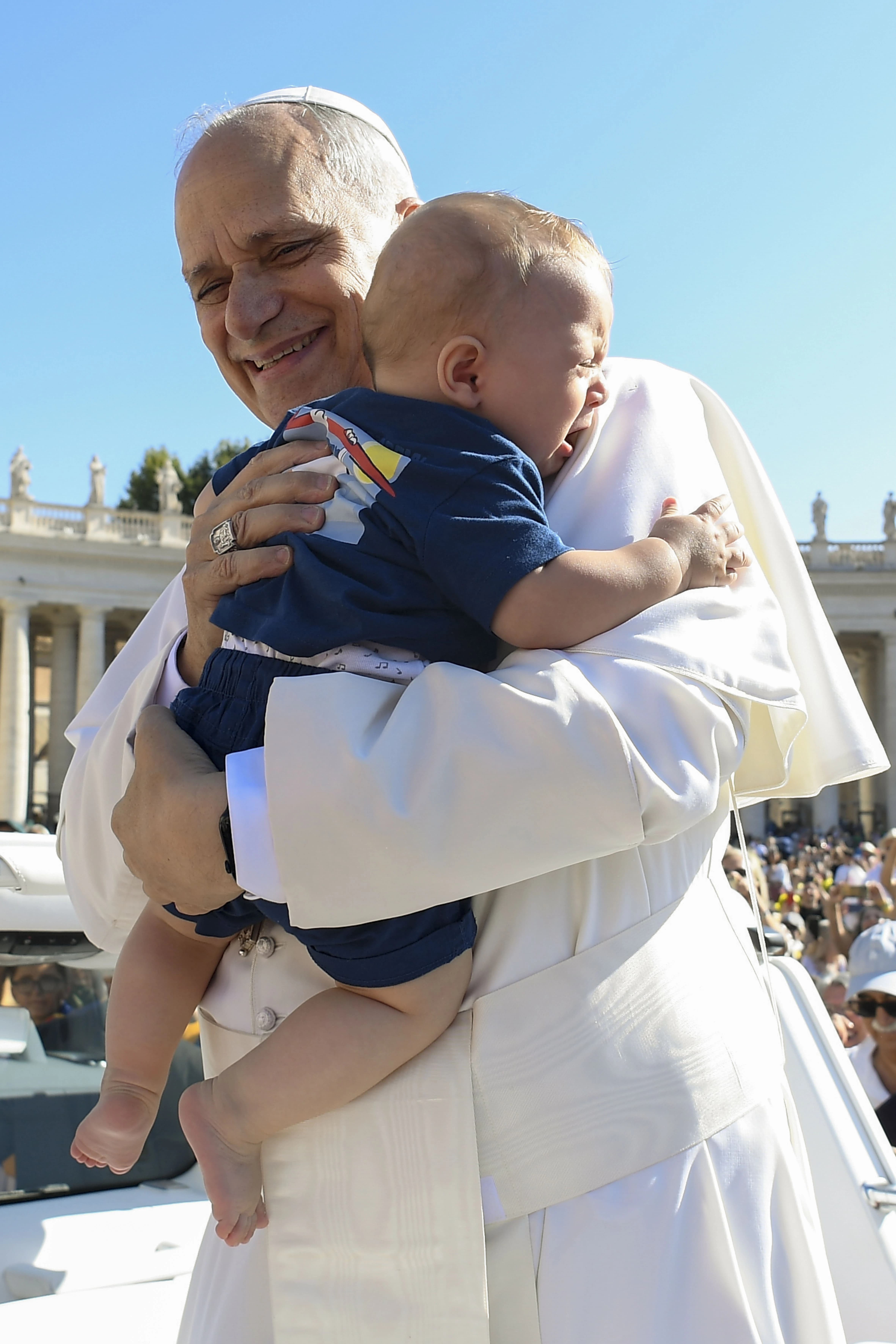 Pope Leo embraces a crying baby in St. Peter's Square on Sept. 6, 2025. Credit: Vatican Media