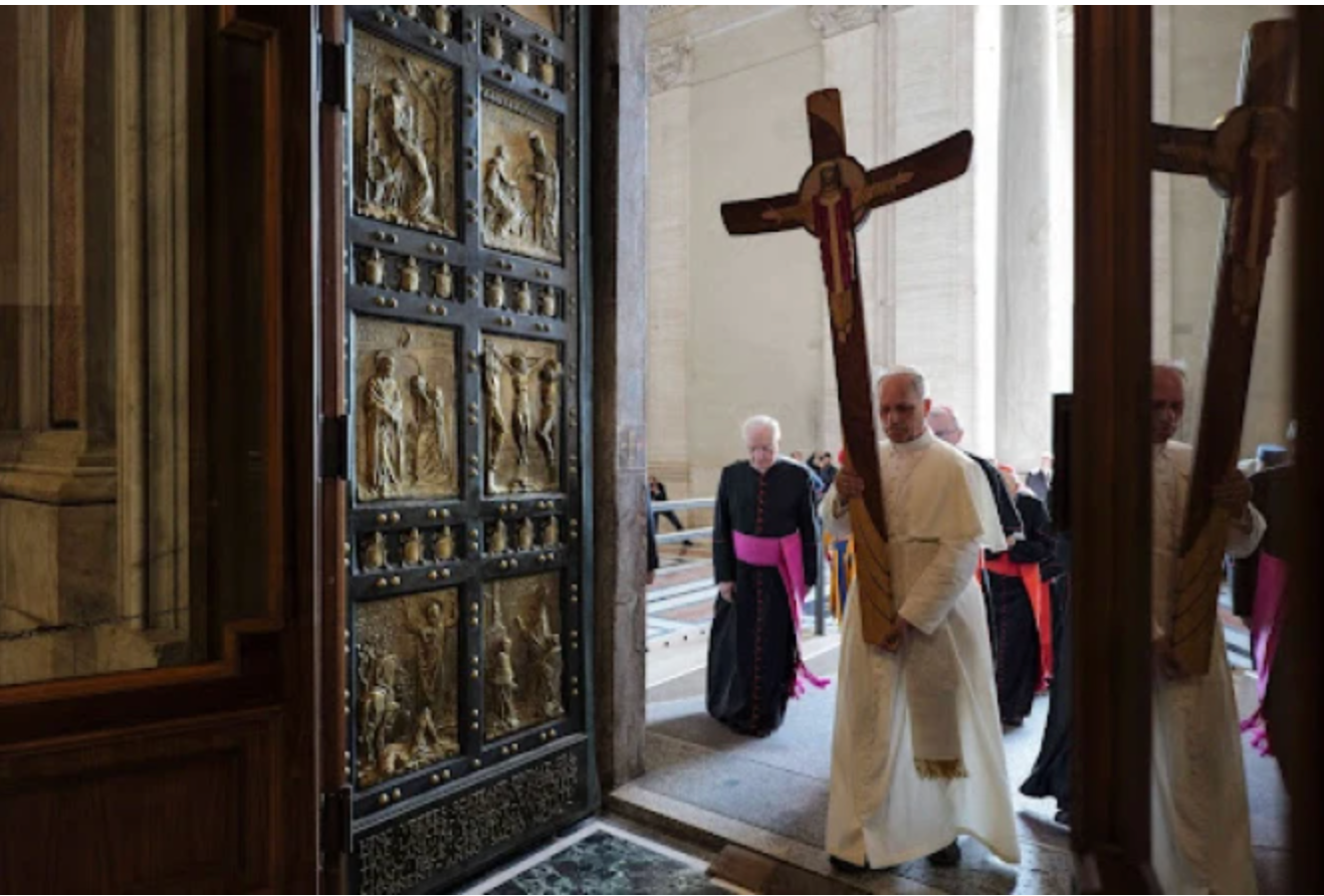Pope Leo XIV walks through the Holy Door carrying the jubilee cross while leading the Holy See’s pilgrimage on June 9, 2025. Credit: Vatican Media