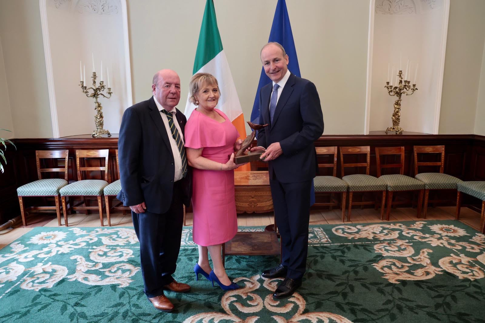 Colin and Eithne Bell with Micheál Martin, Irish Taoiseach. The Bells founded the Kevin Bell Repatriation Trust (KBRT) in 2013 after the death of their son. | Credit: Photo courtesy of the Kevin Bell...