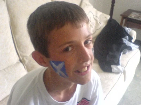 Joe Wilson as a child sporting a Scottish flag in face paint. | Credit: Joe Wilson Association