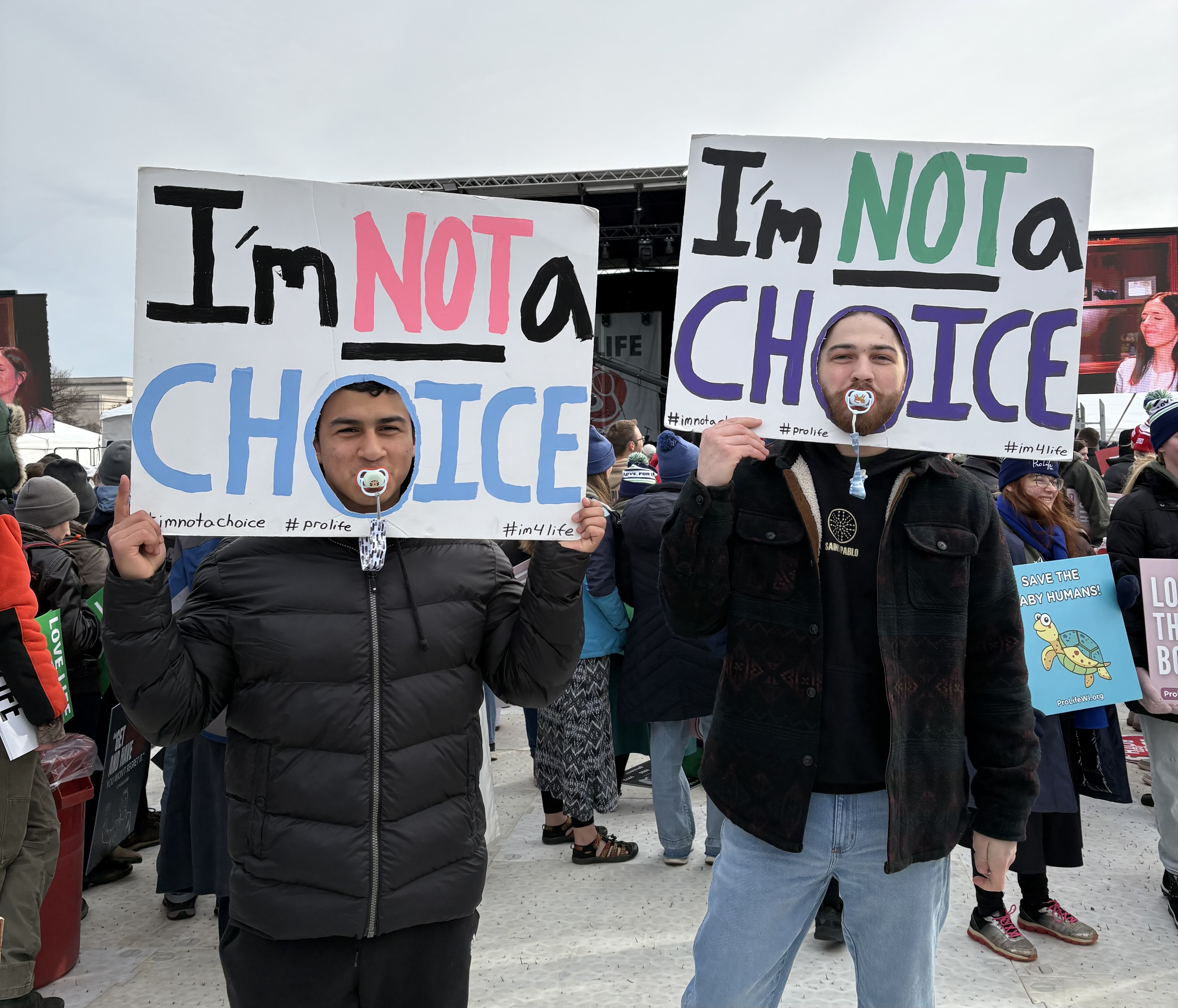 A pro-life pair holds up their handmade signs at the March for Life on Jan. 23, 2026. | Credit: Tessa Gervasini/EWTN News