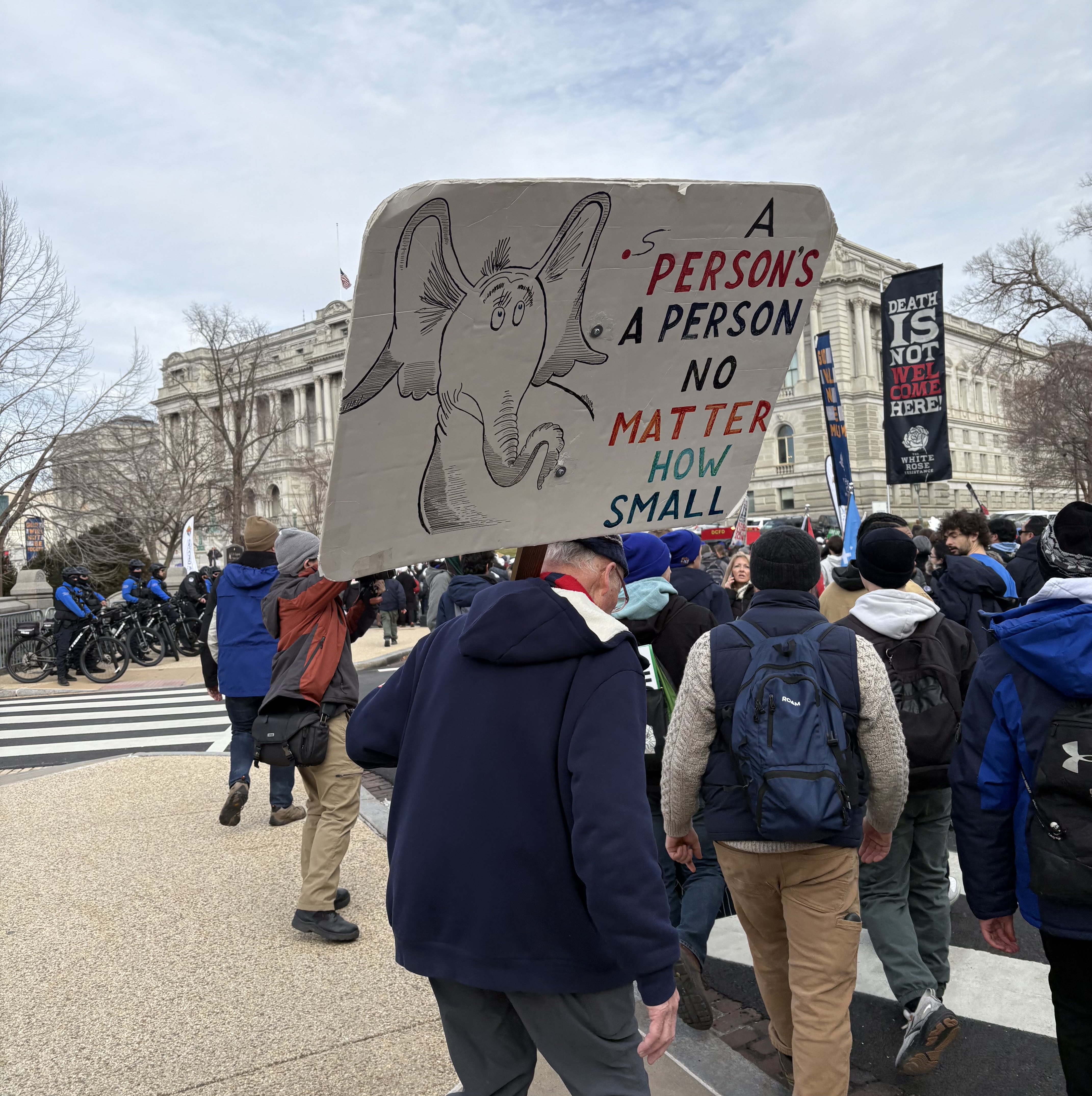 A man carries a “Horton Hears a Who”-inspired sign as he walks at the March for Life on Jan. 23, 2026. | Credit: Tessa Gervasini/EWTN News
