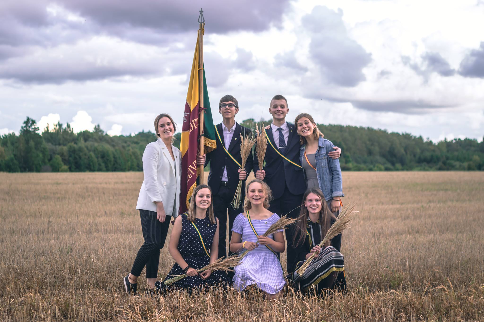 Members of the Ateitis Federation pose with the organization’s flag in the Lithuanian countryside. | Credit: The Ateitis Federation
