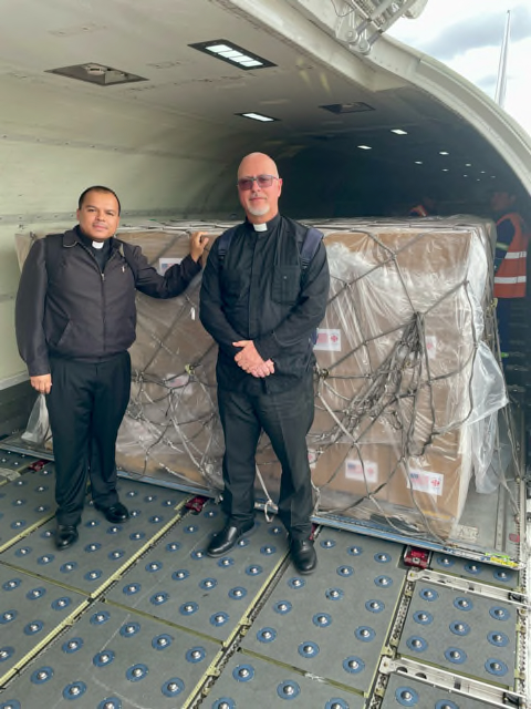 Father Elvis Gonzalez (left) and Father Esney Mu&ntilde;oz Diaz act as guarantors during a U.S. government aid transfer to Catholic Church representatives in Holgu&iacute;n, Cuba, in late January 2026. | Credit: Photo courtesy of Catholic Charities of the Archdiocese of Miami