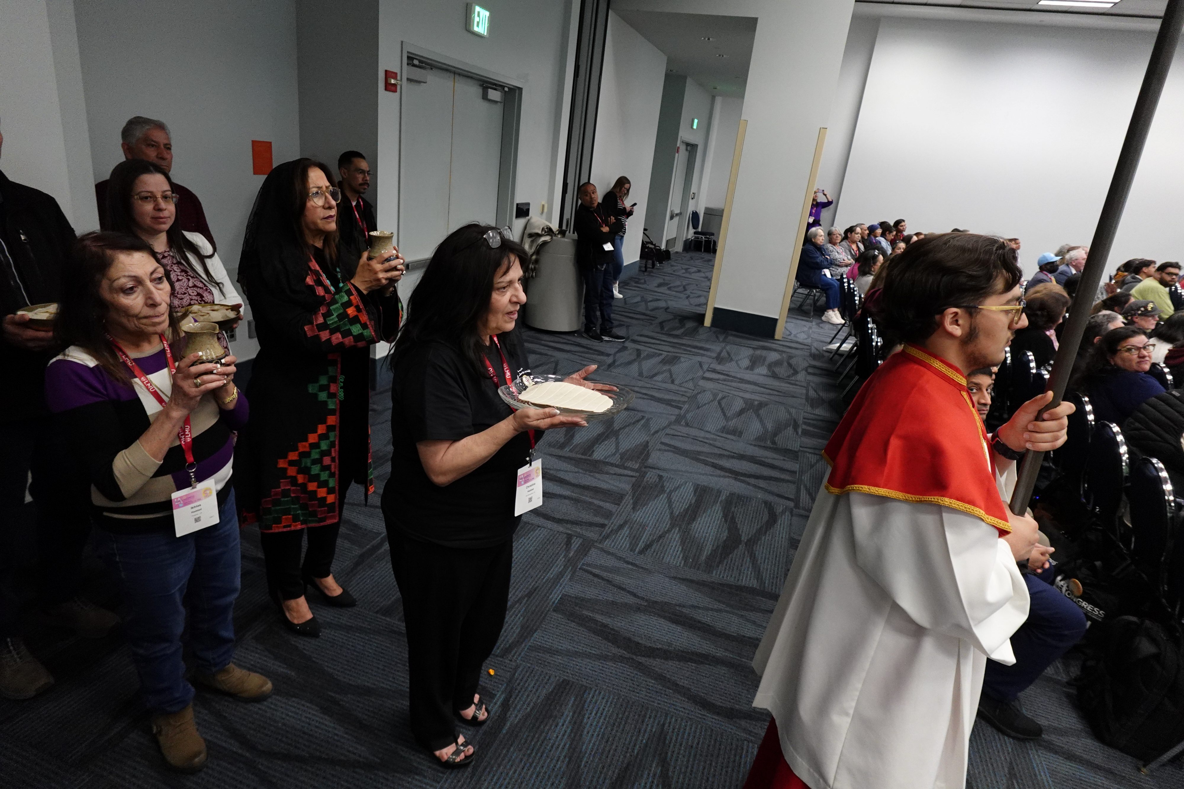 Massgoers bring up the Eucharistic gifts during the first-ever Arabic Mass at RECongress that was attended by hundreds on Feb. 21, 2026. | Credit: Katie Trejo