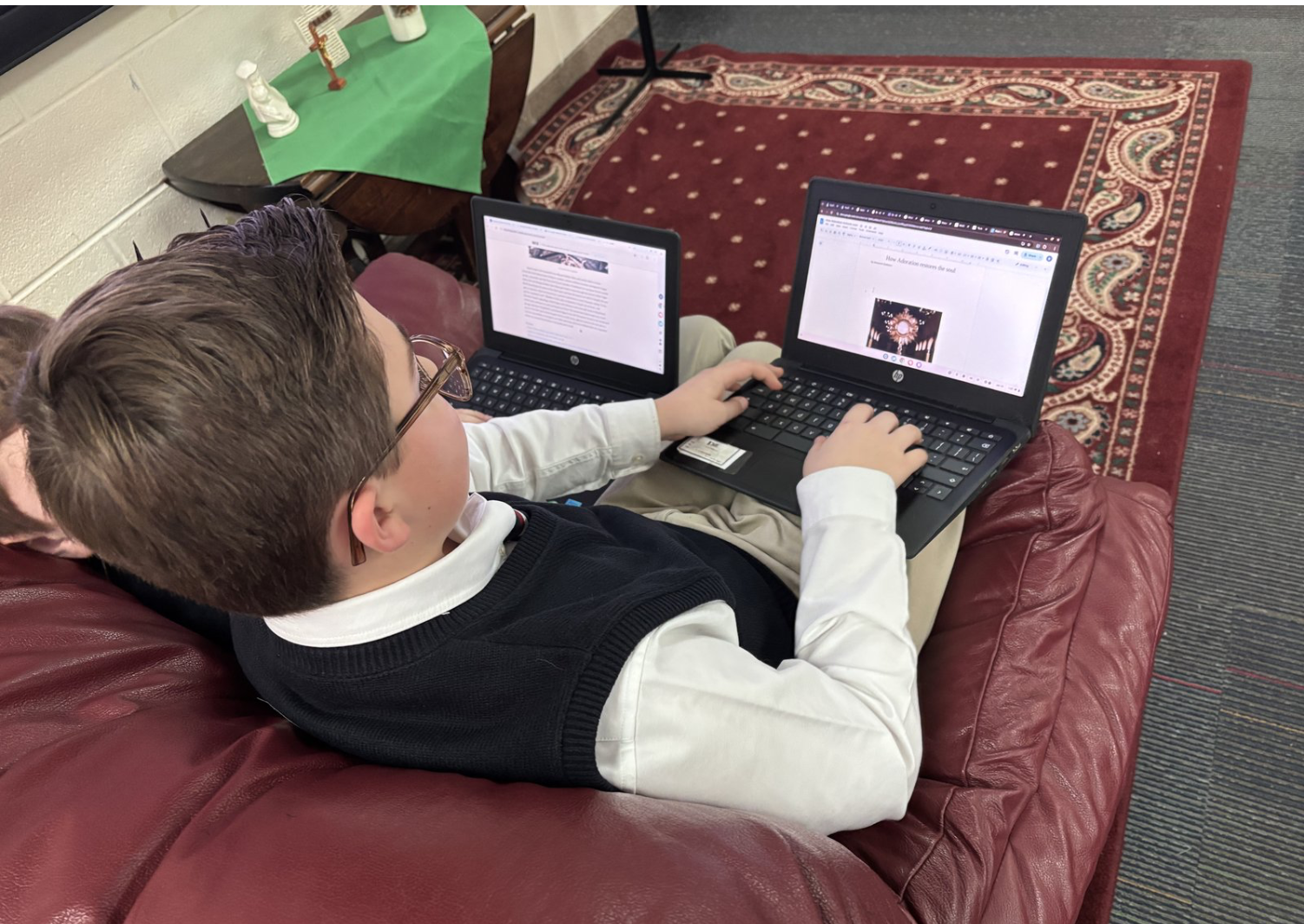 A middle school student at St. Joseph School in Lake Orion, Michigan,  reviews an article in Luis Nava’s online newspaper, The Catholic Michigander. | Credit: Photo courtesy of Luis Nava/Detroit Catholic