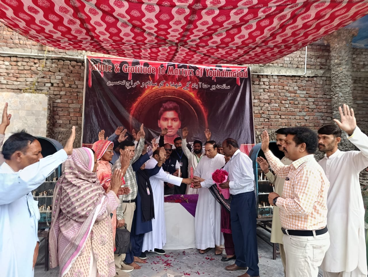 Father Akram Javed (fifth from right), parish priest of St. John&rsquo;s Catholic Church, lights a memorial candle for Servant of God Akash Bashir at a commemoration in Youhanabad, Lahore, Pakistan, on March 15, 2025. |
Credit: Kamran Chaudhry