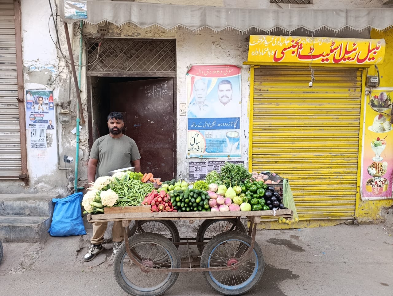 Sunil Masih stands beside his vegetable cart in front of his family&rsquo;s former
milk shop in Youhanabad, Lahore, Pakistan, on March 15, 2025. | Credit:
Kamran Chaudhry