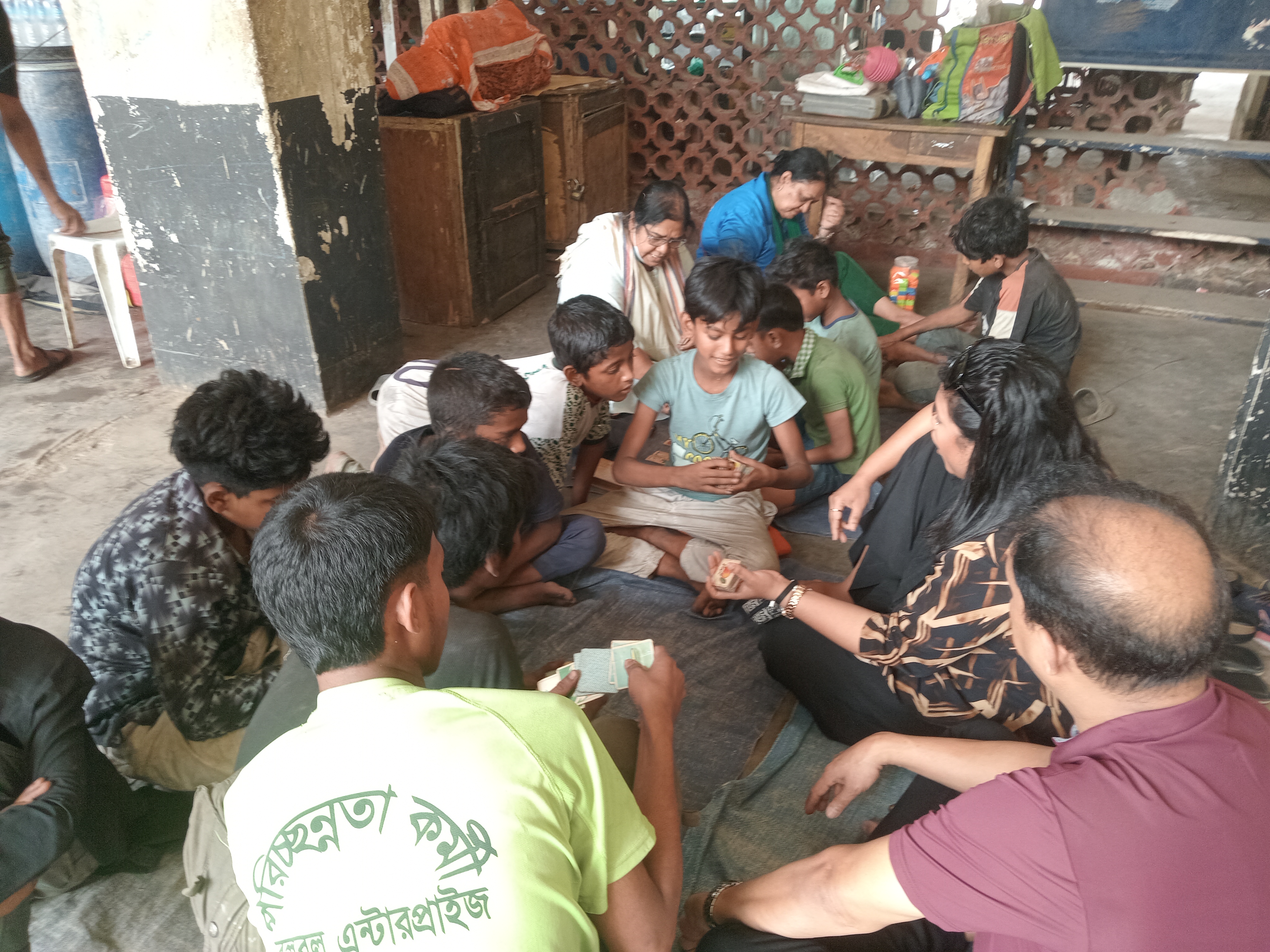 Catholic volunteers sit with street children during an activity session
in Dhaka, Bangladesh, on March 14, 2026. | Credit: Sumon Corraya