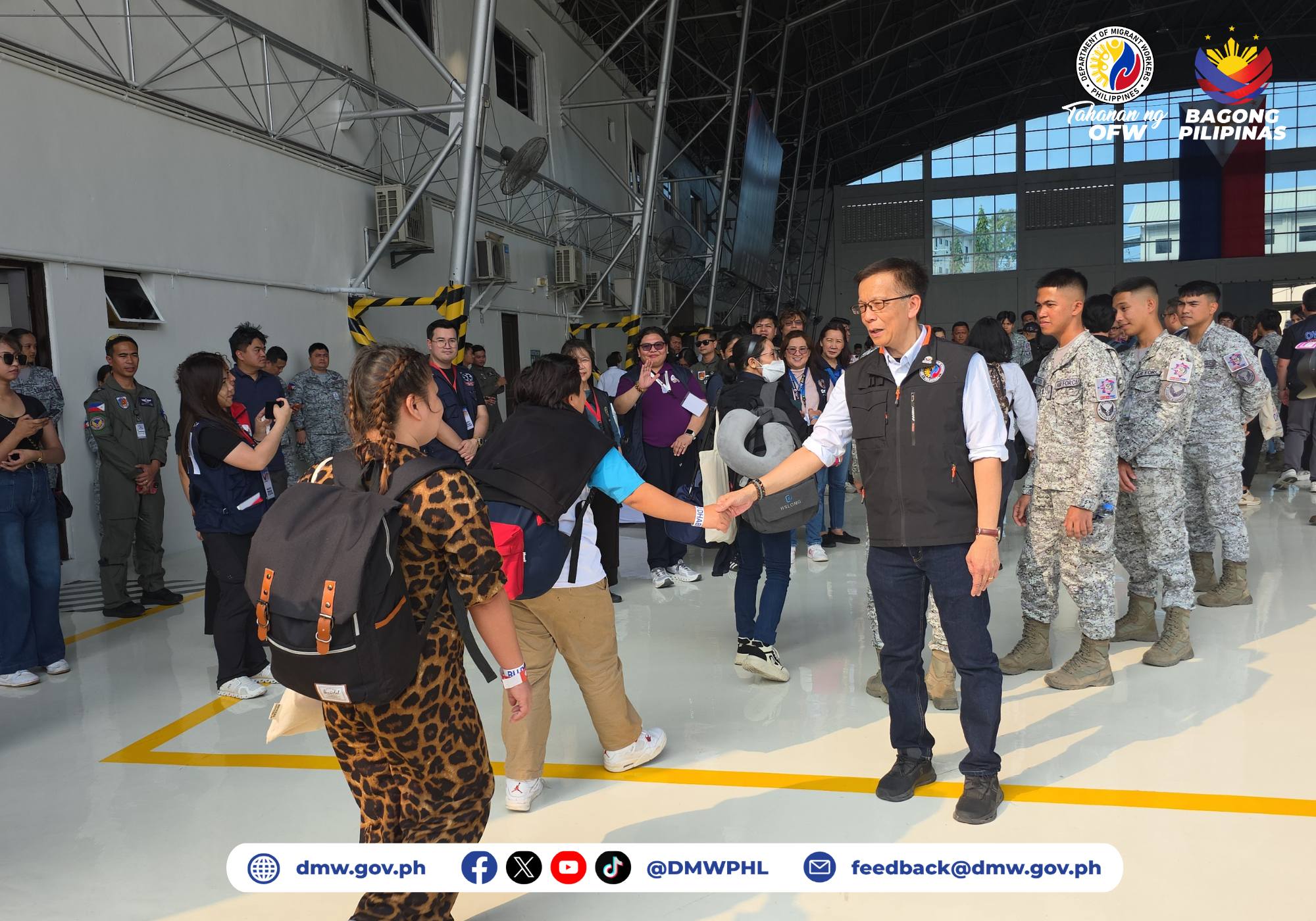 Hans Leo Cacdac, the secretary of the Department of Migrant Workers in the Philippines, welcomes Filipino migrant workers who were stranded in the United Arab Emirates and are back in the Philippines aboard the sixth government-chartered flight that landed at Villamor Air Base in Pasay City on March 29, 2026. | Credit: Photo courtesy of Department of Migrant Workers