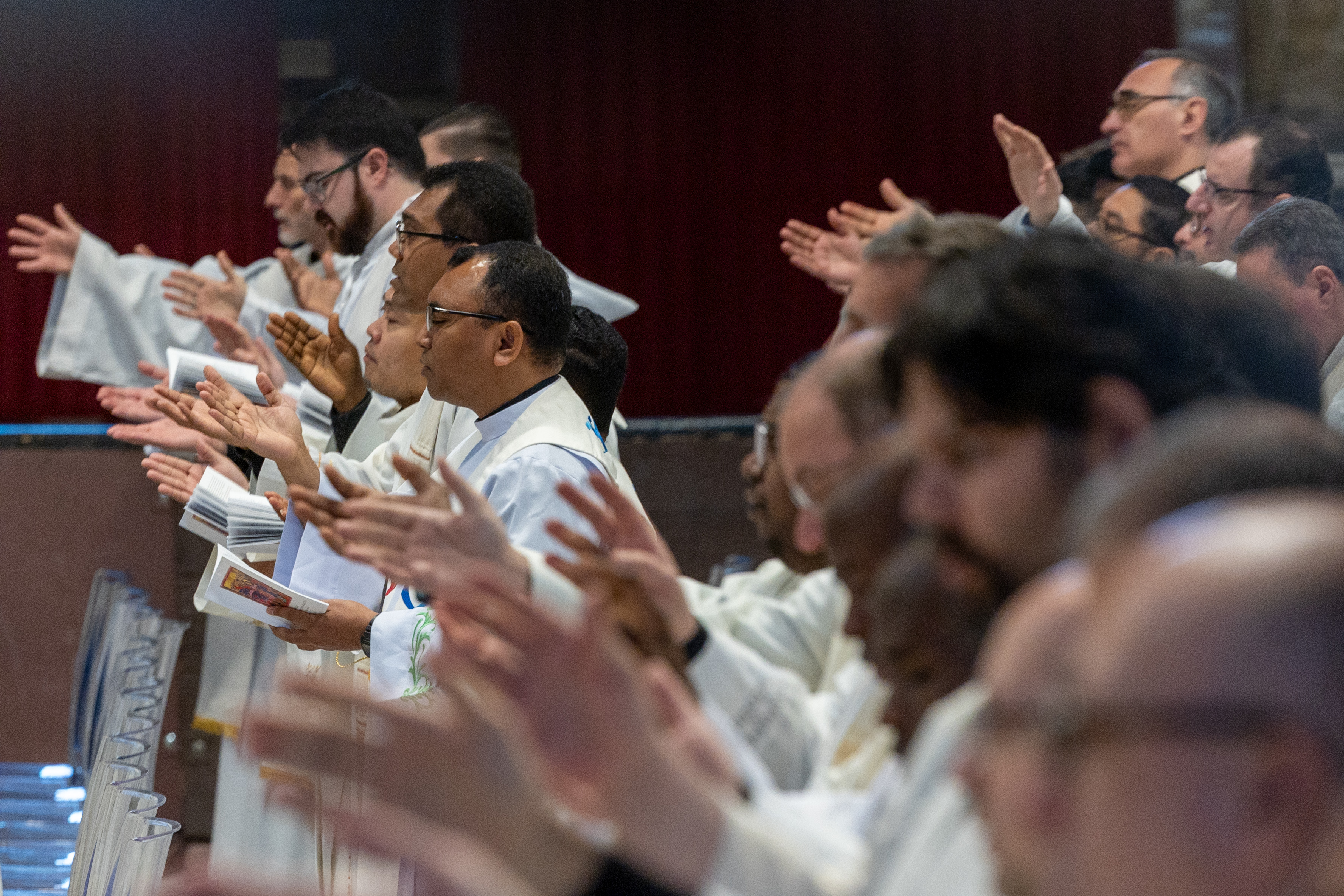 Clergy raise their hands in prayer during a chrism Mass at the Vatican on Holy Thursday, April 2, 2026. | Credit: Daniel Ib&aacute;&ntilde;ez/EWTN News