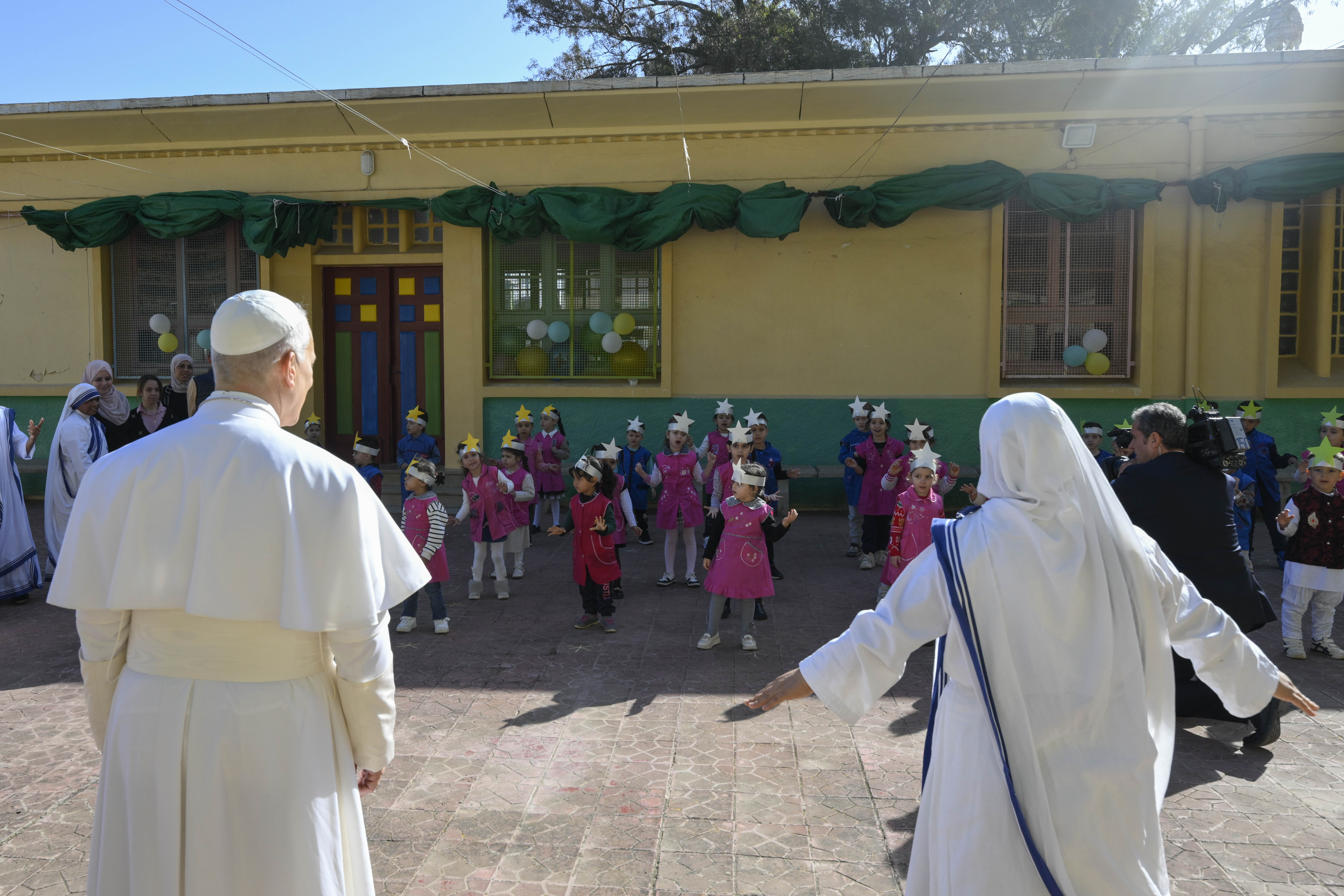 Pope Leo XIV watches a performance by children at the Notre Dame d’Afrique Kindergarten, run by the Missionary Sisters of Charity, near Algiers, Wednesday, April 15, 2026. | Credit: Vatican Media