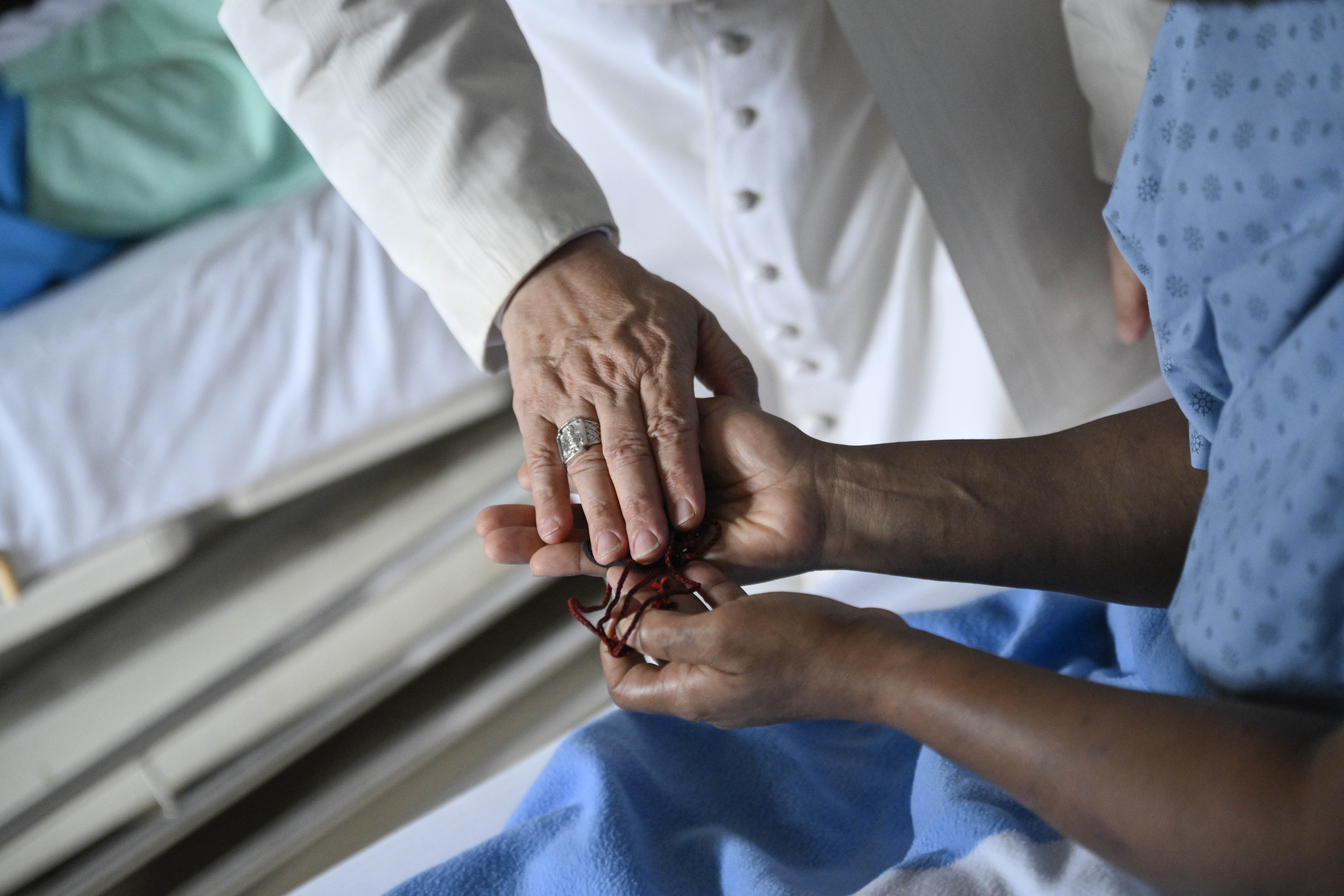 Pope Leo XIV offers a blessing to a patient at St. Paul Catholic Hospital in Douala, Cameroon, on Friday, April 17, 2026. | Credit: Vatican Media