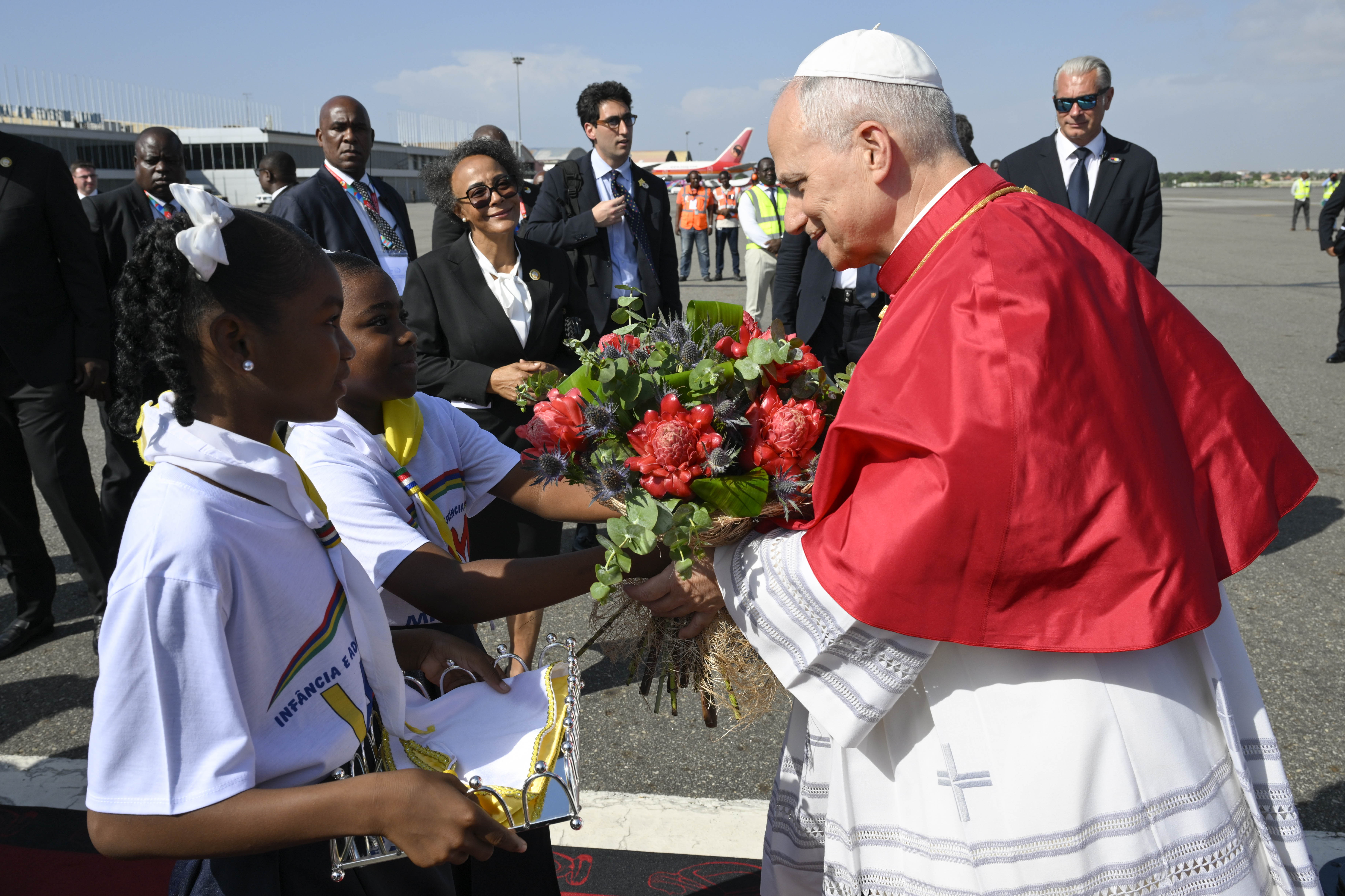 Pope Leo XIV receives flowers upon his arrival at Quatro de Fevereiro Airport in Luanda, Angola, Saturday, April 18, 2026. | Credit: Vatican Media