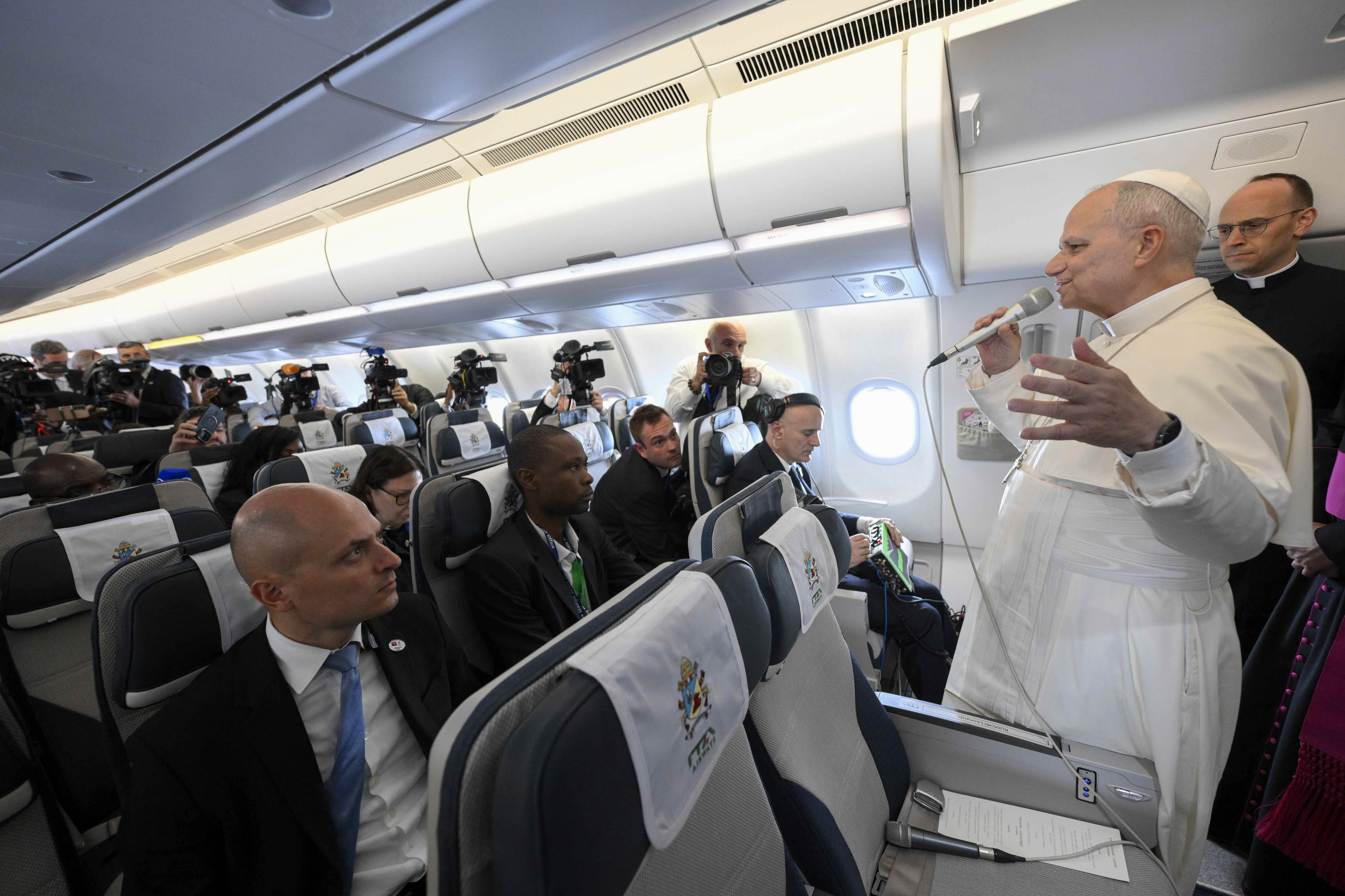 Pope Leo XIV speaks to journalists aboard the papal plane en route to Quatro de Fevereiro Airport in Luanda, Angola, Saturday, April 18, 2026. | Credit: Vatican Media